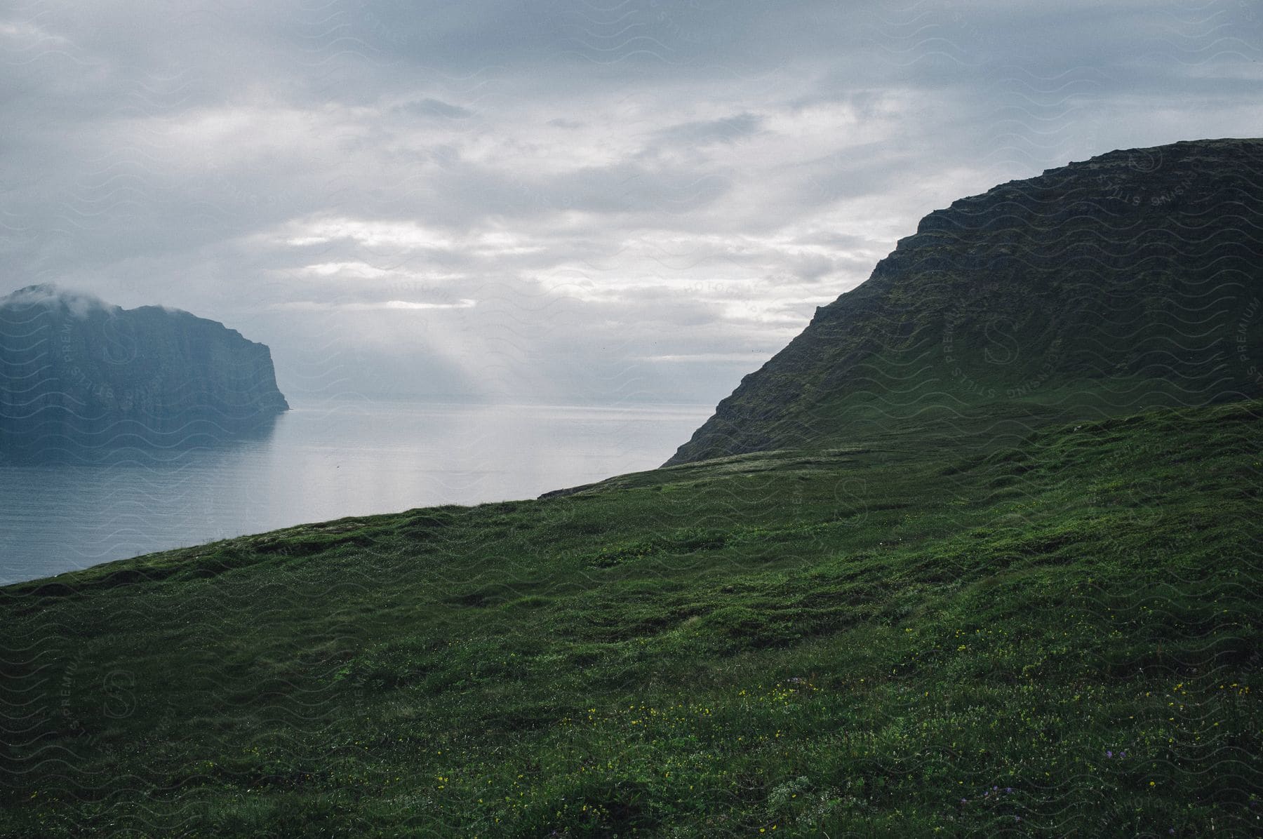 A Tranquil Coastal Landscape With Mountains Water And Vegetation