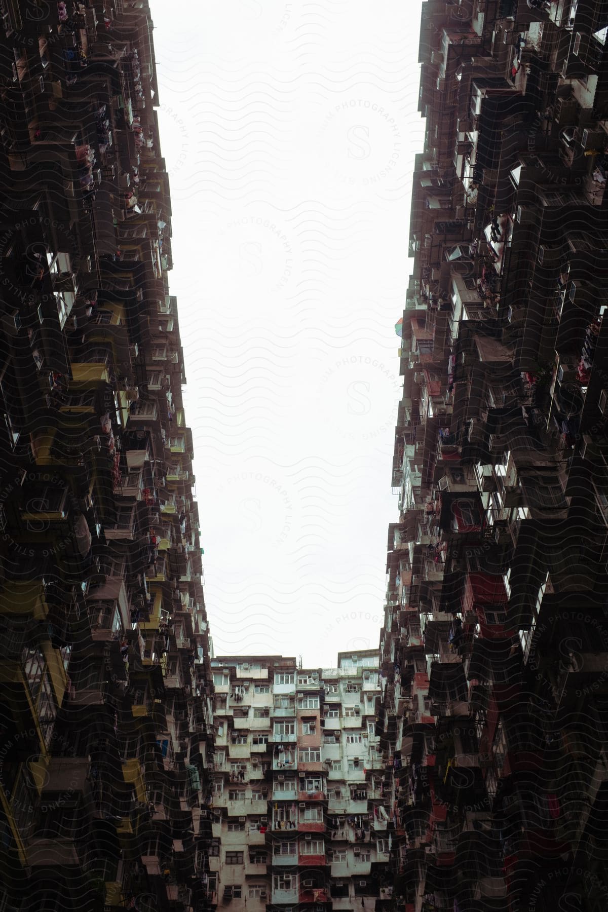 Urban cityscape featuring highrise buildings and a road surrounded by housing and infrastructure