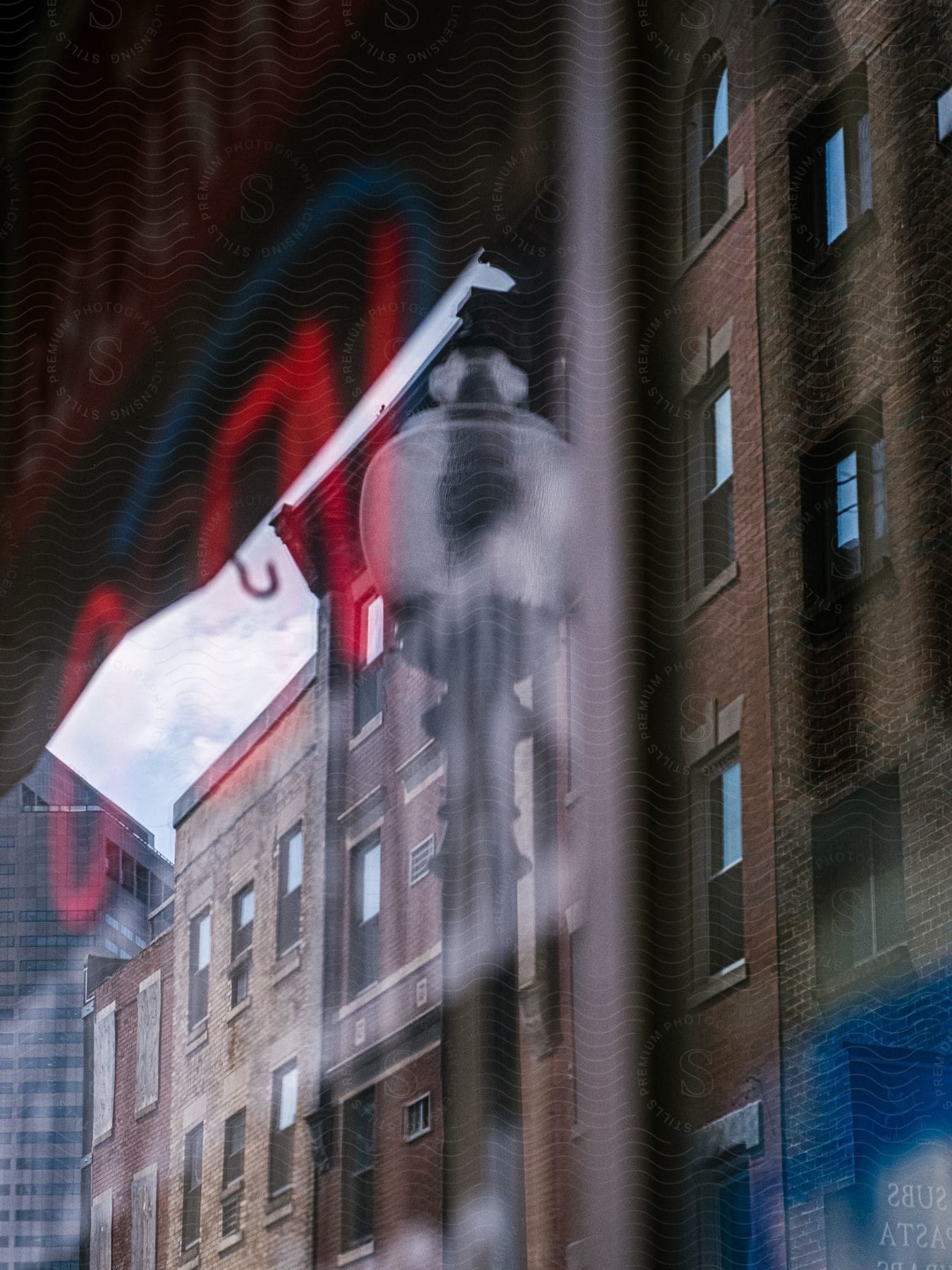 Downtown neighborhood with reflected apartment and office buildings seen against a window