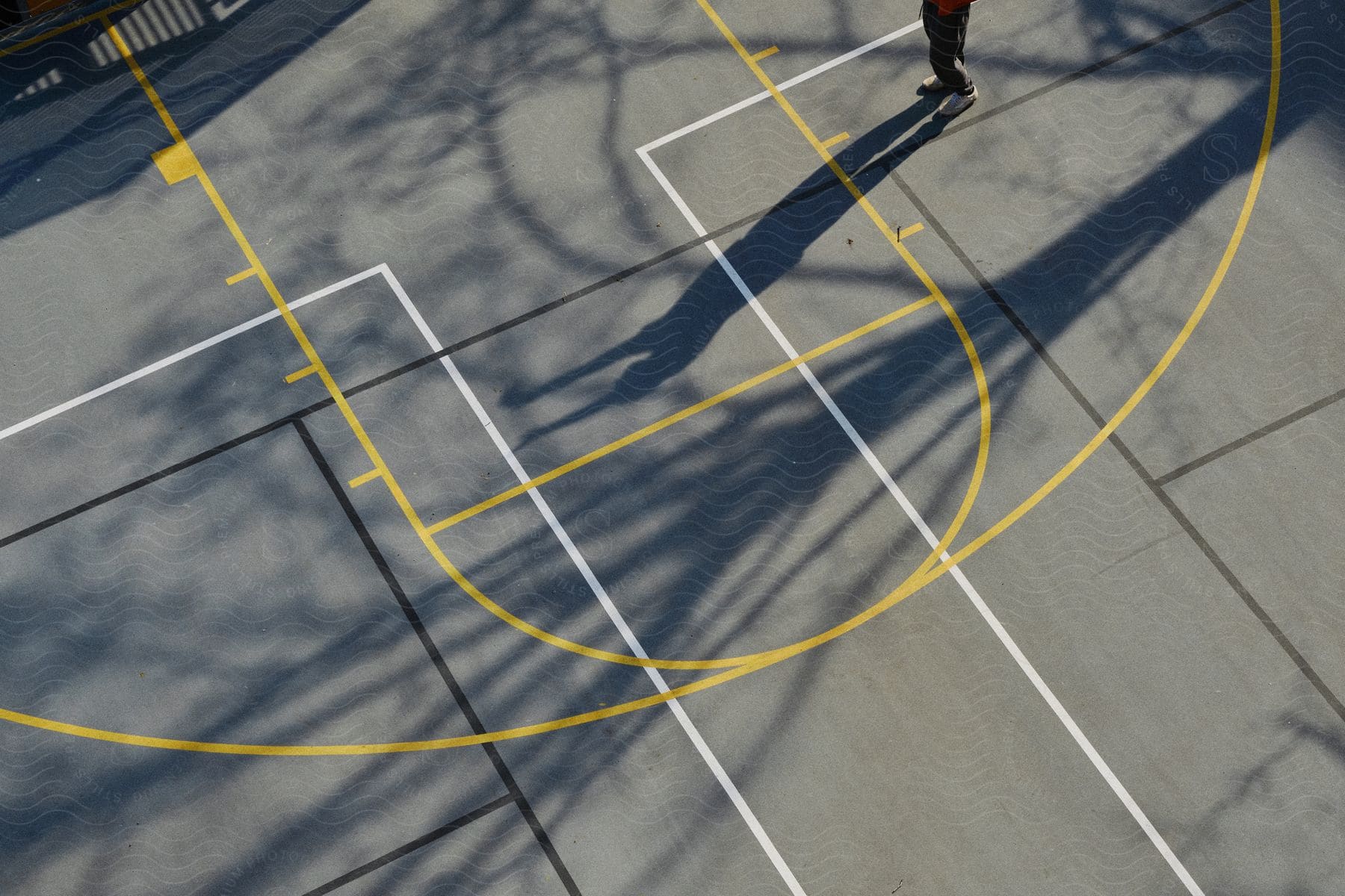 A line drawing on the ground showing the legs of a man in motion captured midstride