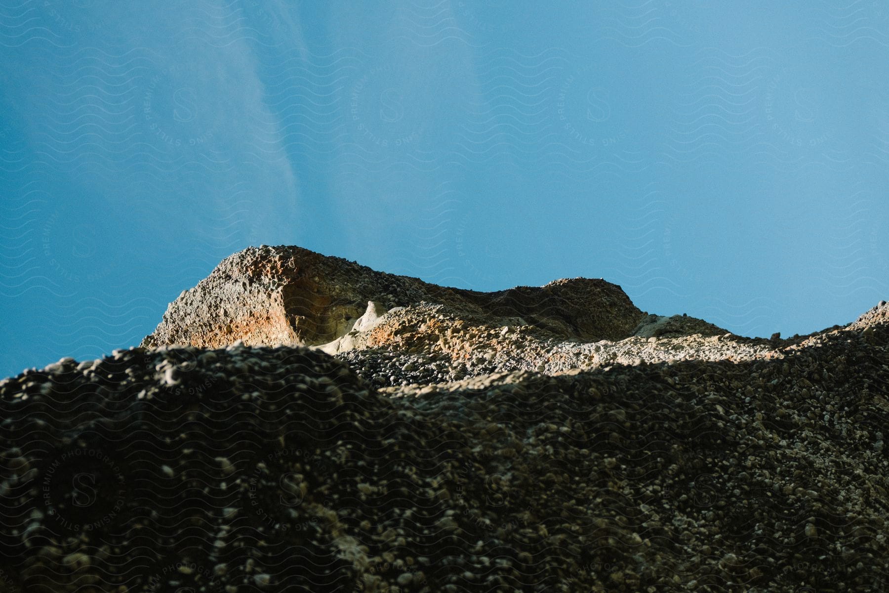 Landscape with sandy soil on a sunny day in patagonia featuring mountains and rocky terrain