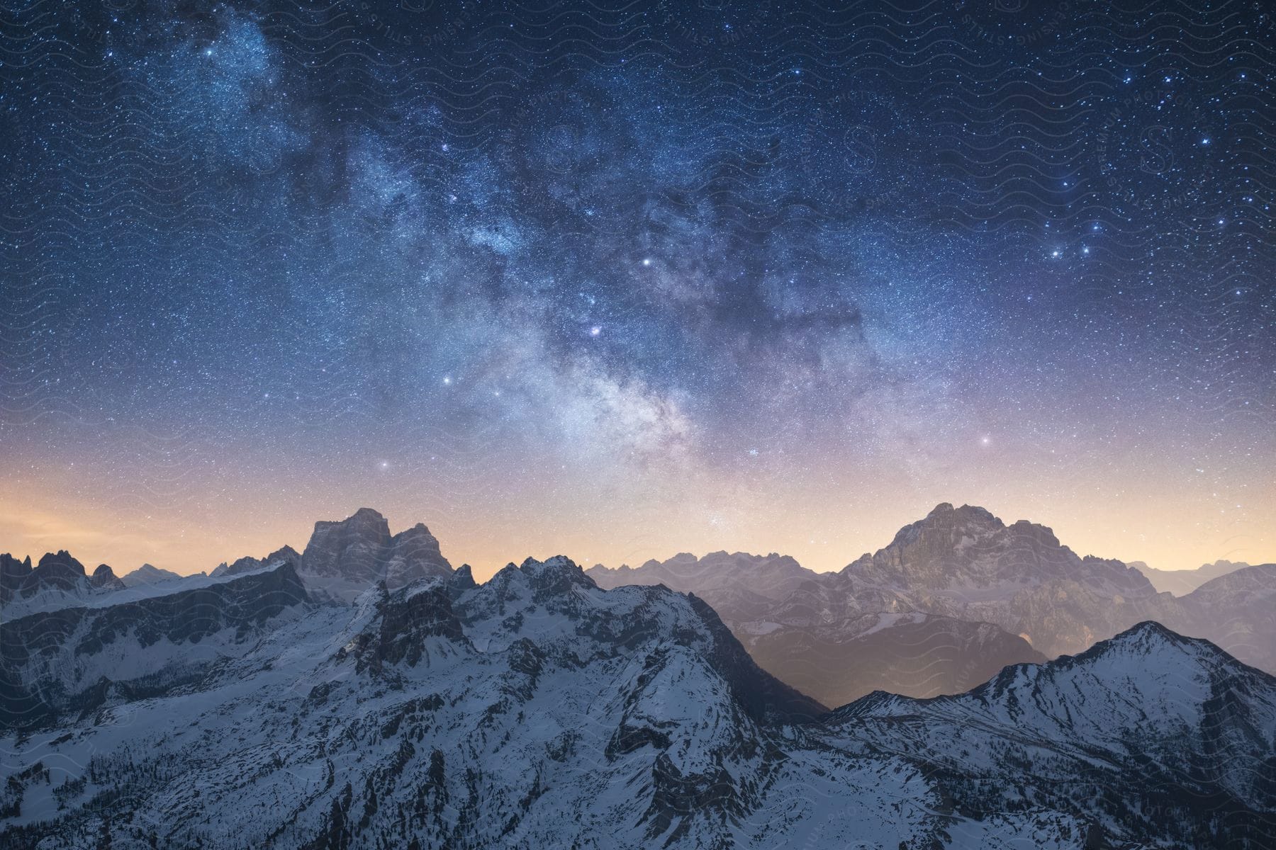 A night view of snowcovered mountains in the dolomites with a clear sky