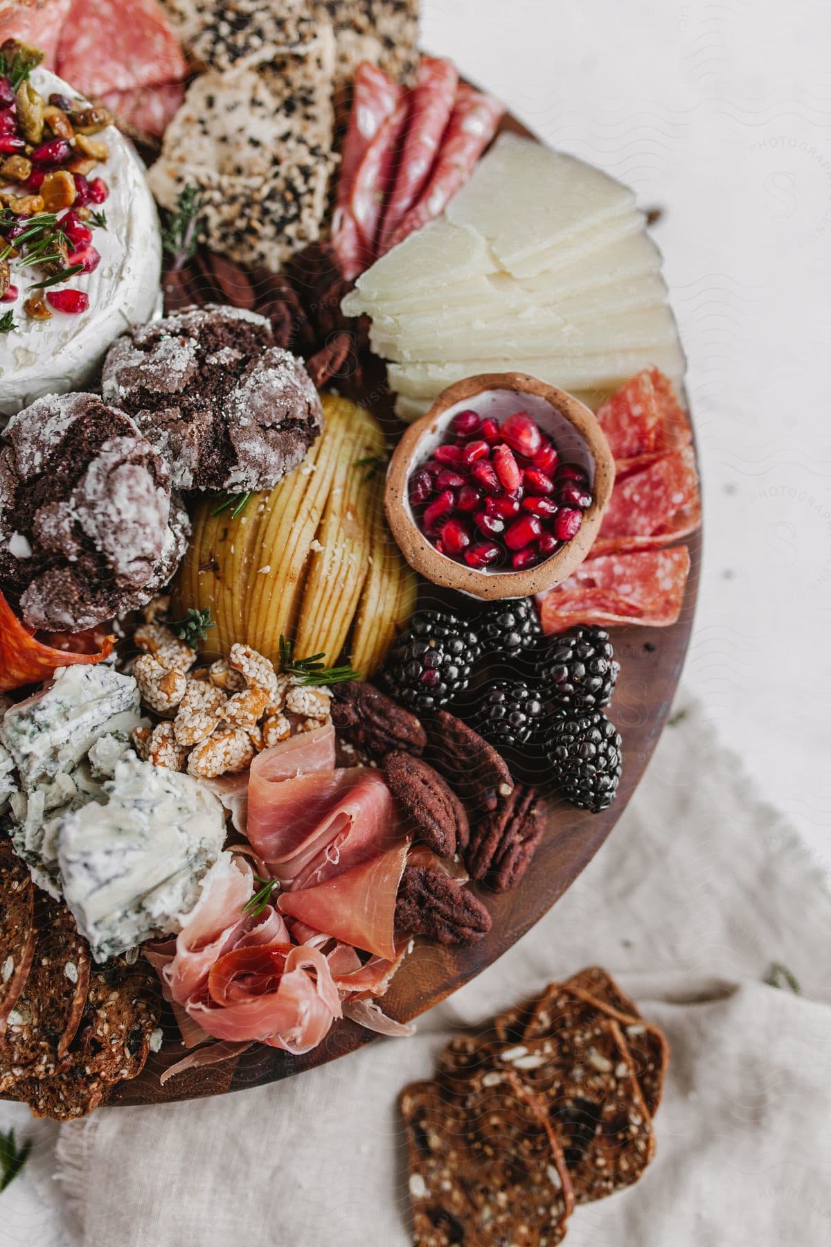 A charcuterie board filled with a variety of meats cheeses and fruits