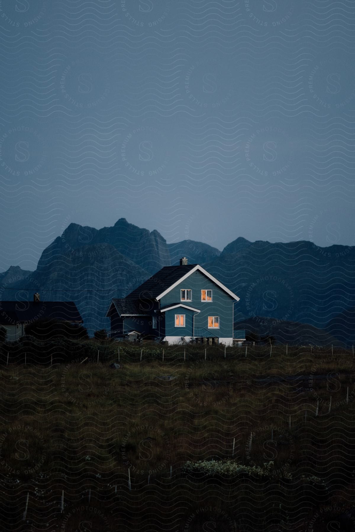 A rural house in the countryside with a mountain backdrop