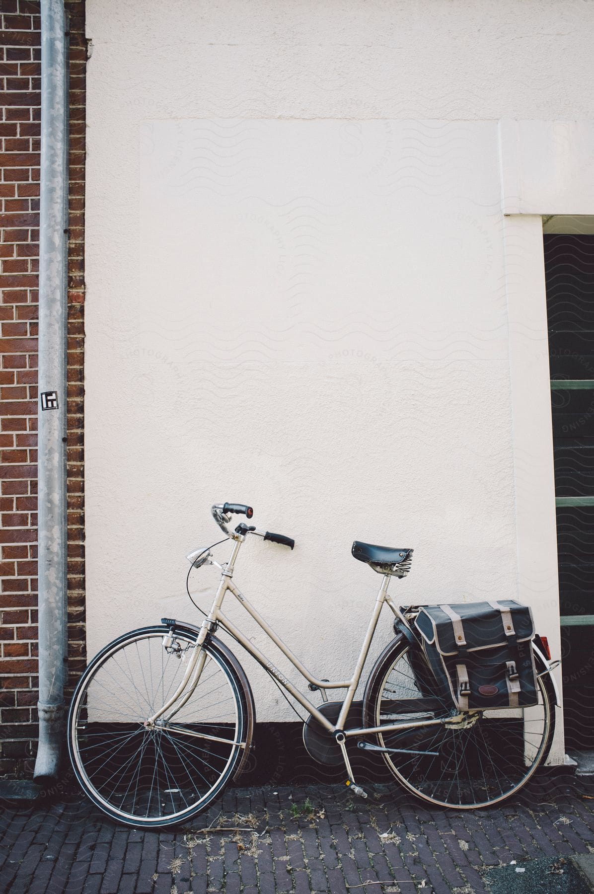 A commuter bicycle with bike pannier bags outside a building