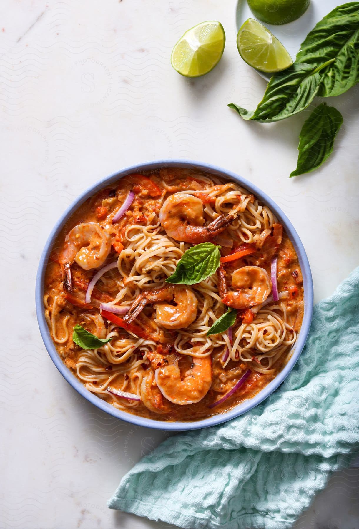 A meal featuring shrimp noodles and a red creamy sauce