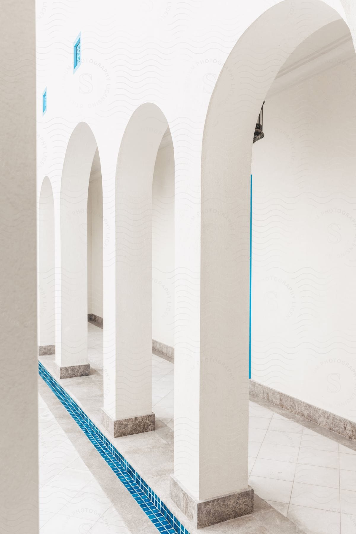 Empty room with architectural features and geometric patterns on the floor and walls