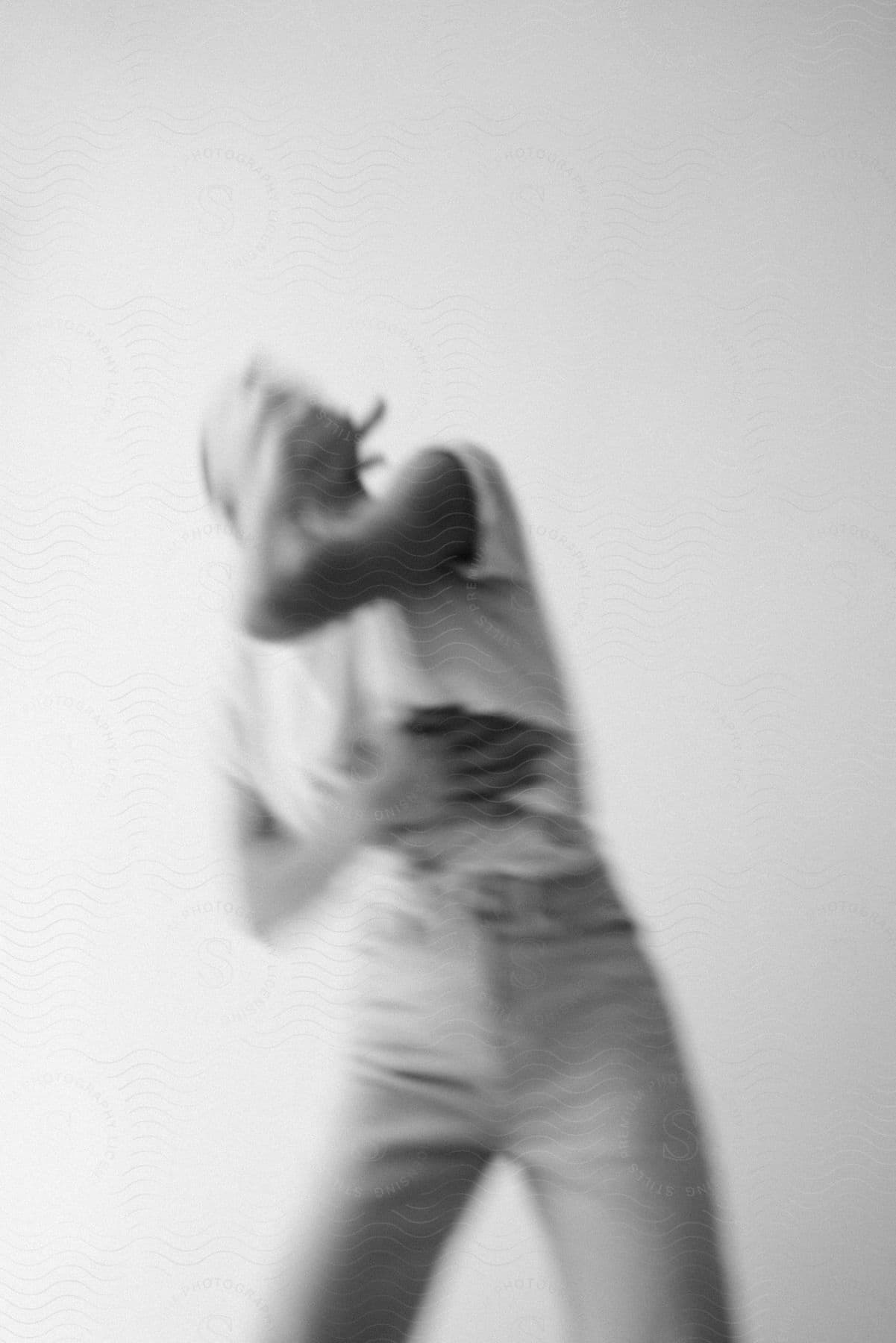 Stock photo of a person performing a gesture in a blurry photograph