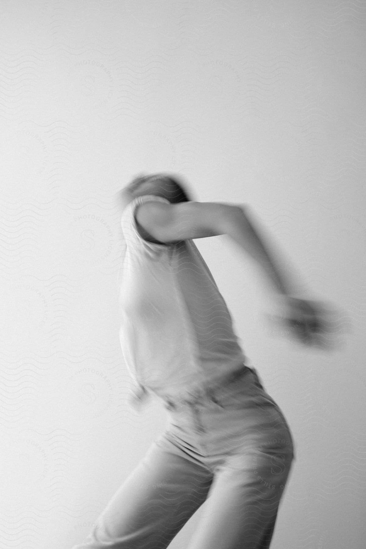 A woman dances in front of a white background