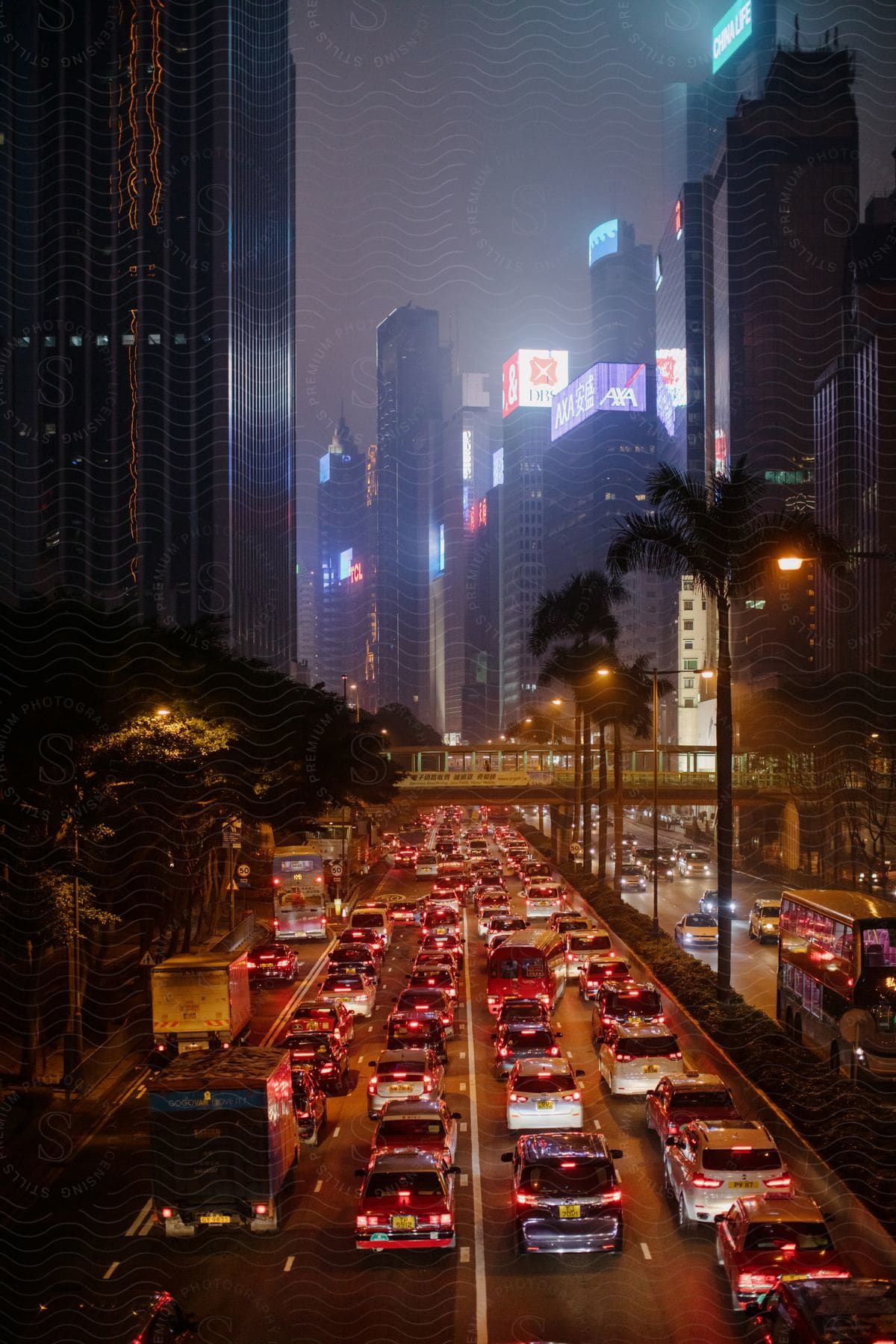 Urban cityscape at night with heavy traffic and huge skyscrapers in hong kong