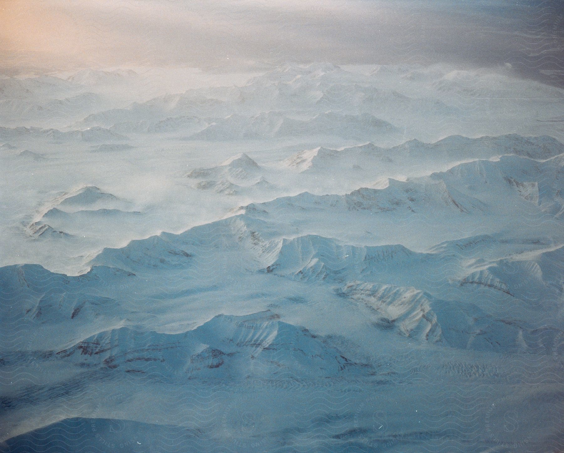 A cloudy and snowy mountain range in svalbard norway