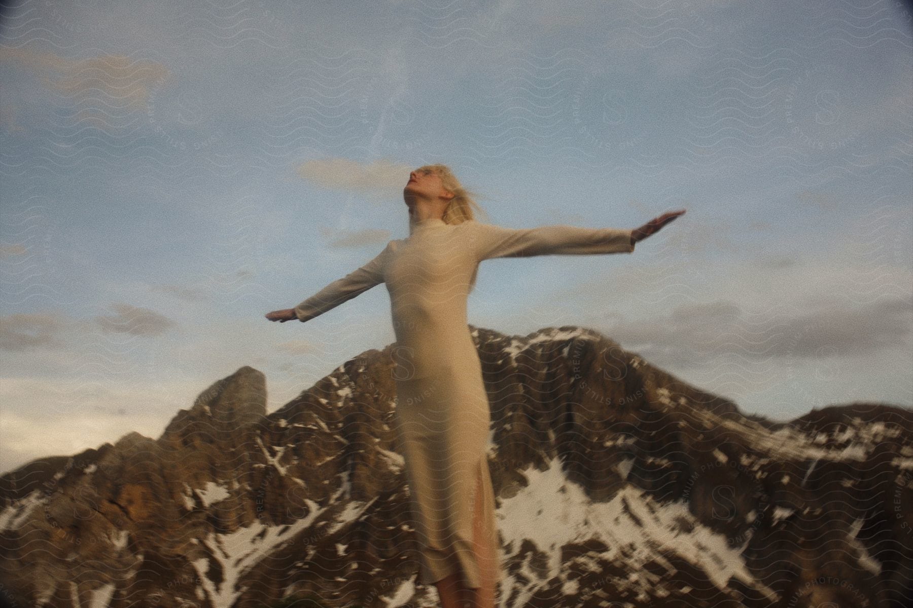 A woman standing on a cliff in nature