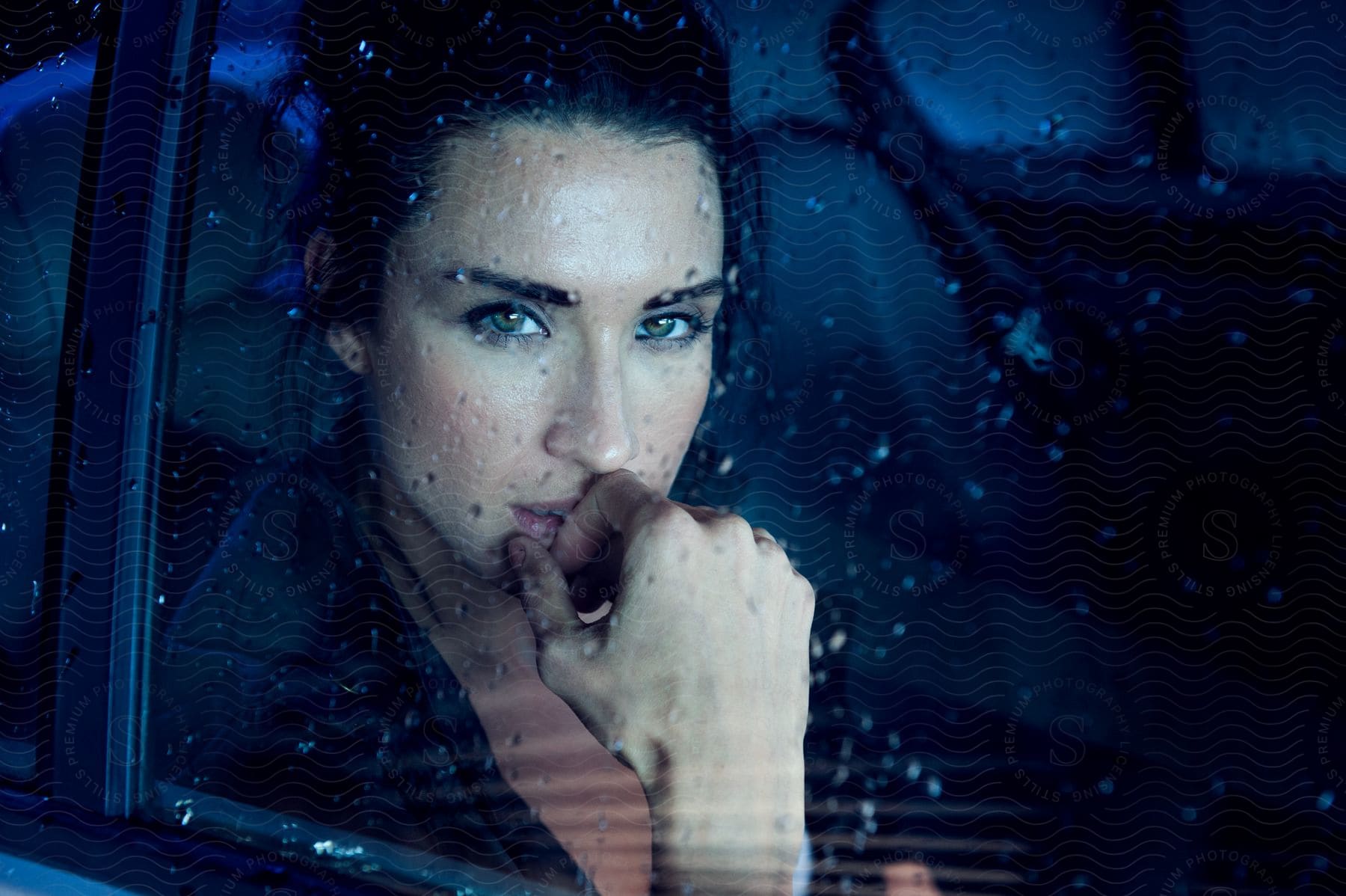 A Woman With A Thoughtful Expression Looks Out Of A Car Window