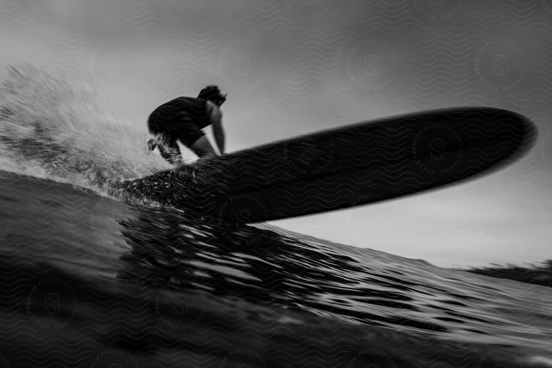 A young man surfing during the day.