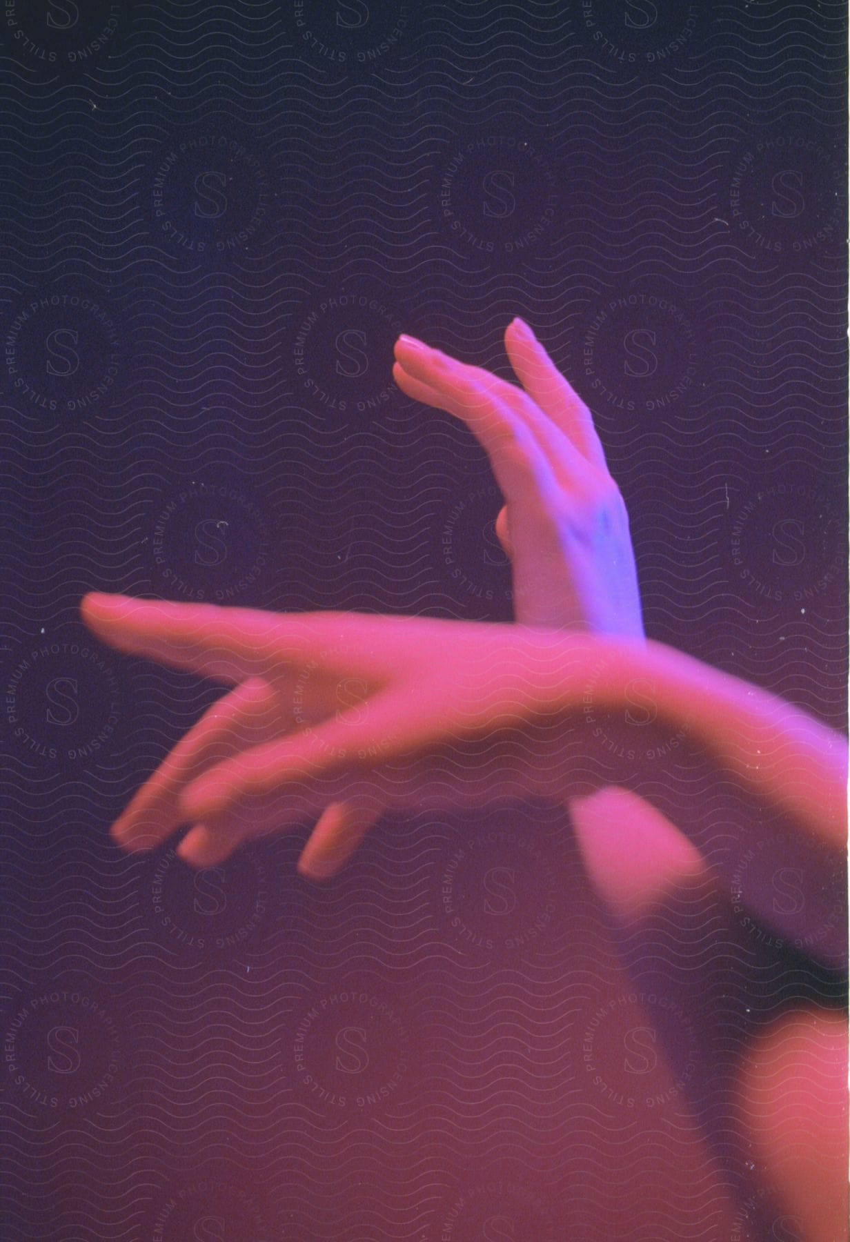 A persons hand with a pink gesture