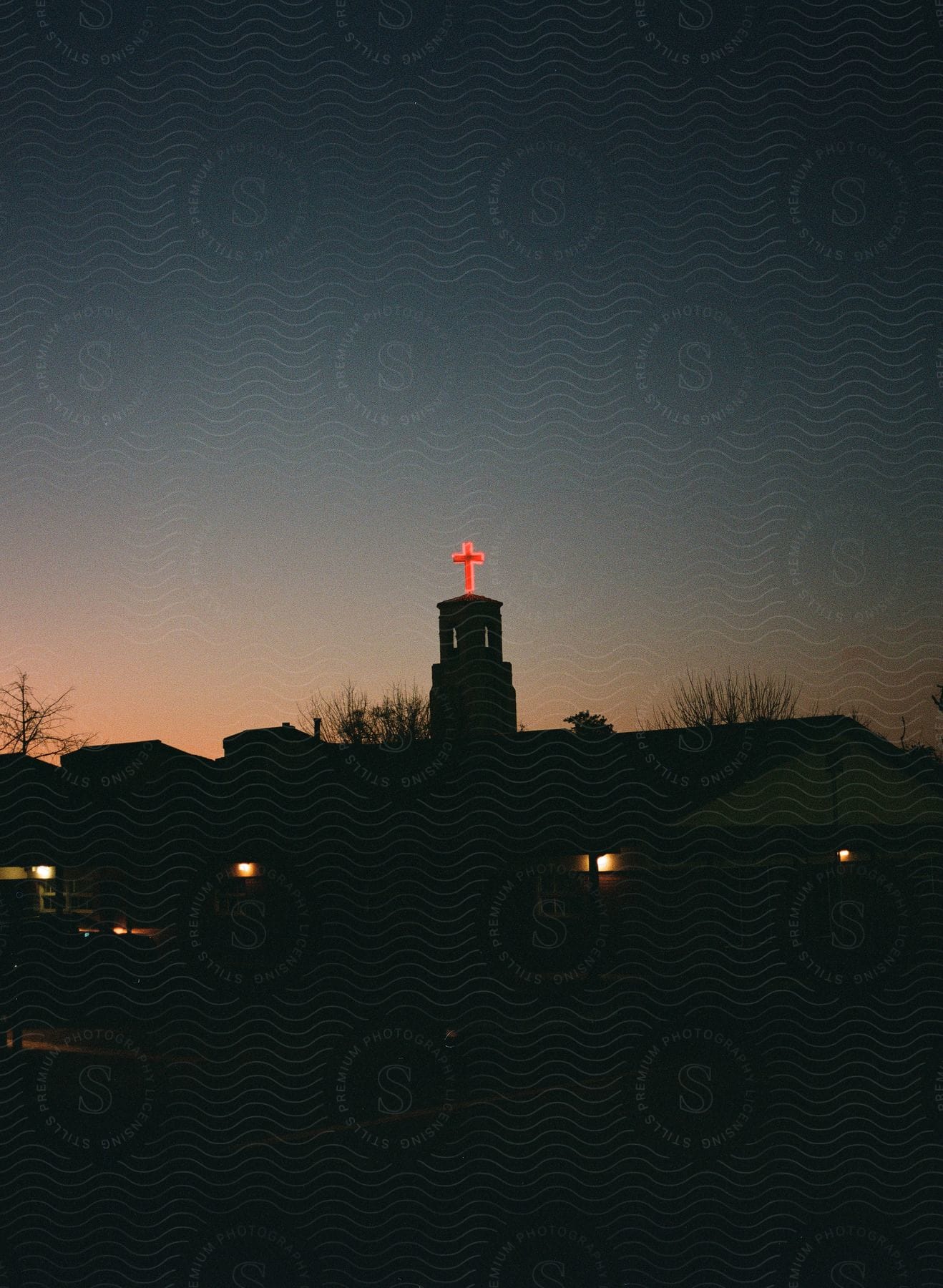 A building silhouette against a red sky at dusk