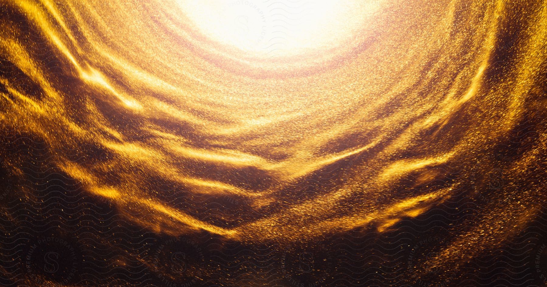 a tunnel of golden particles, with a bright light at the end.