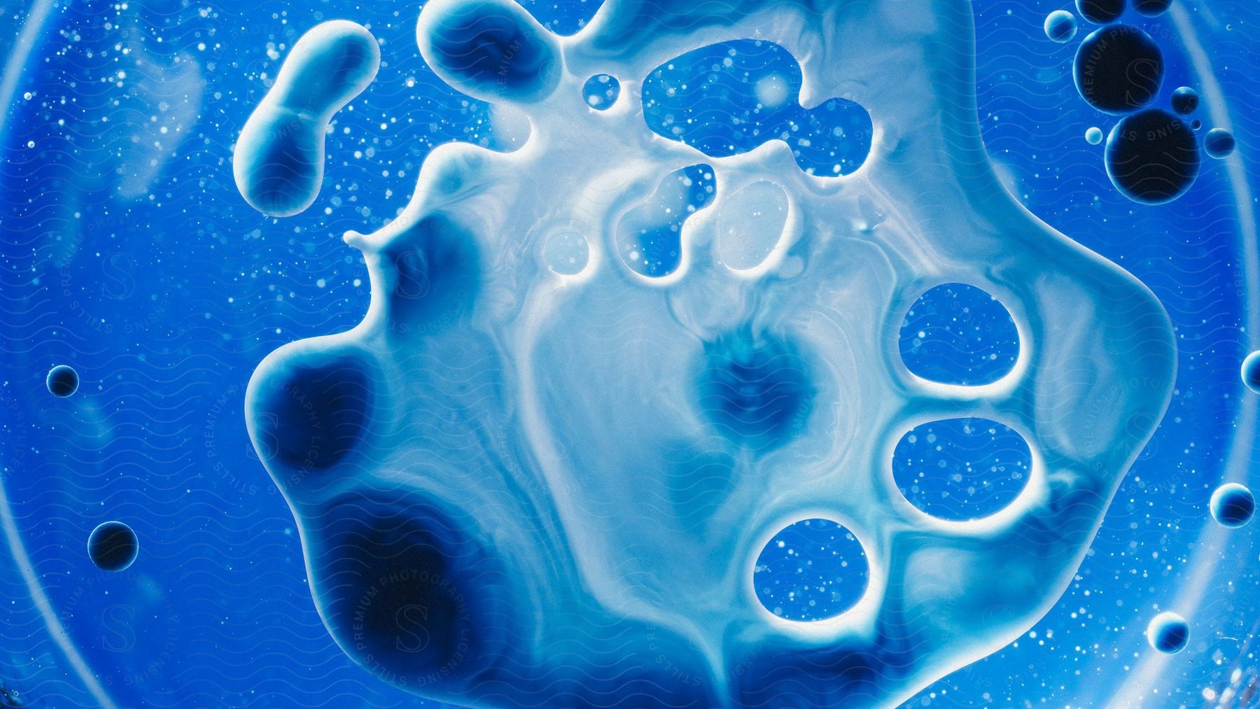 A thick blue liquid with globule-like formations.