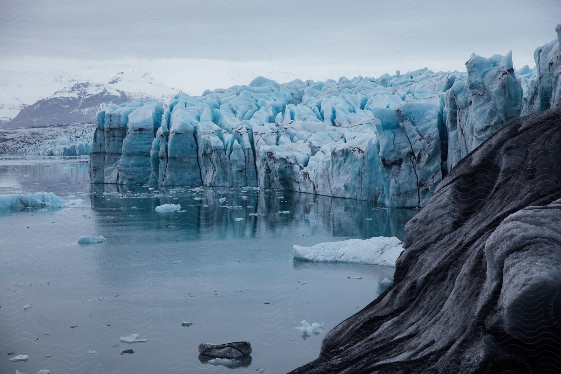 A serene winter landscape with mountains water and ice