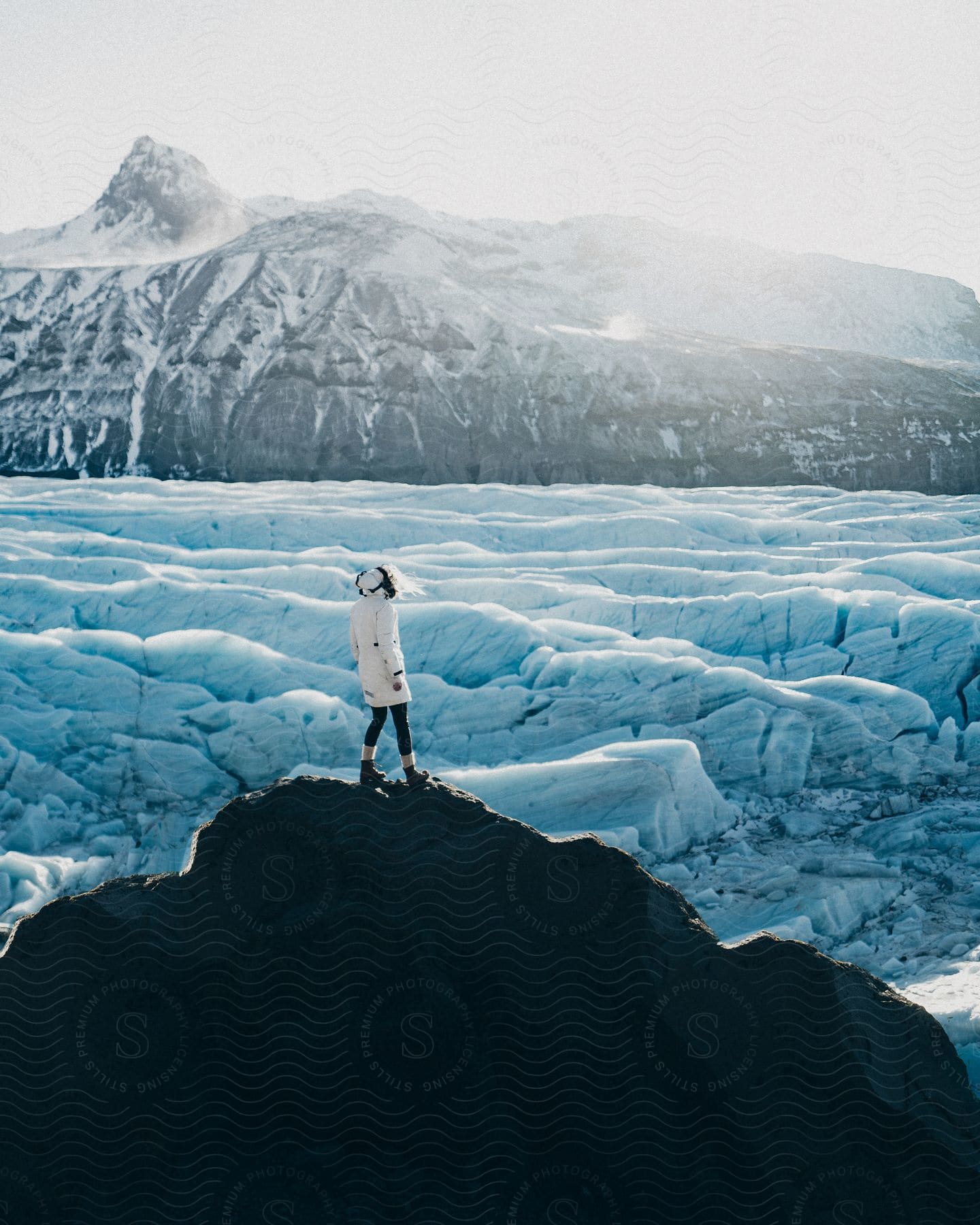 A woman hiking through an arctic landscape