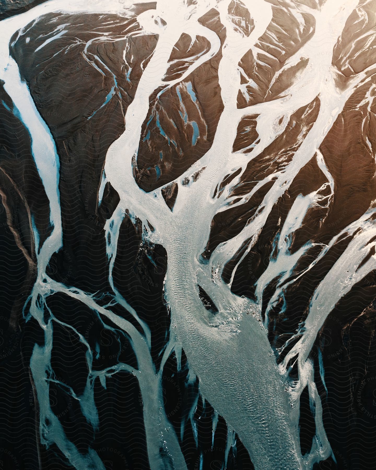 Stock photo of frozen and thawing rivers in a remote region captured from above during the day