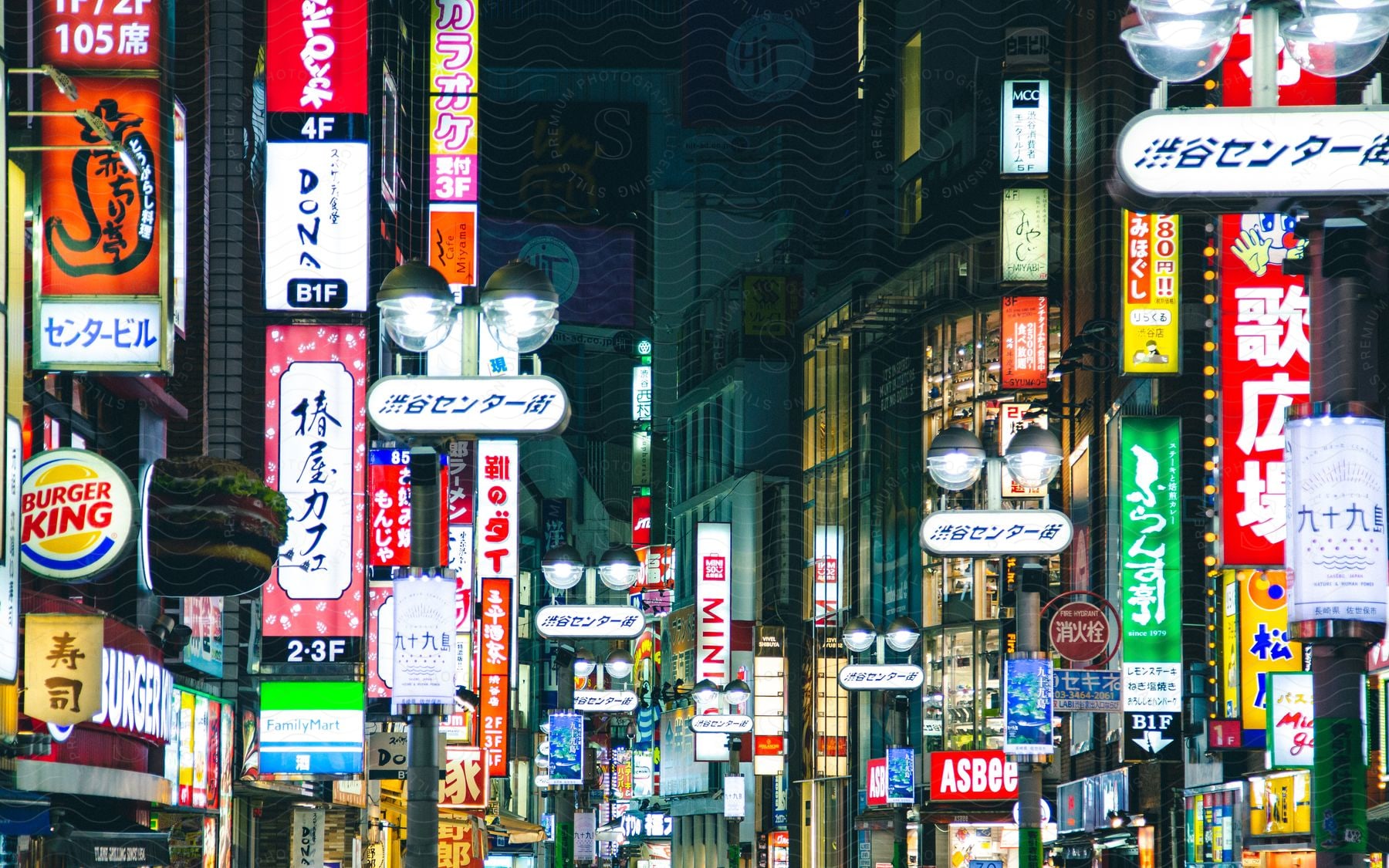 Colorful shop signs on a busy city street at night in japan