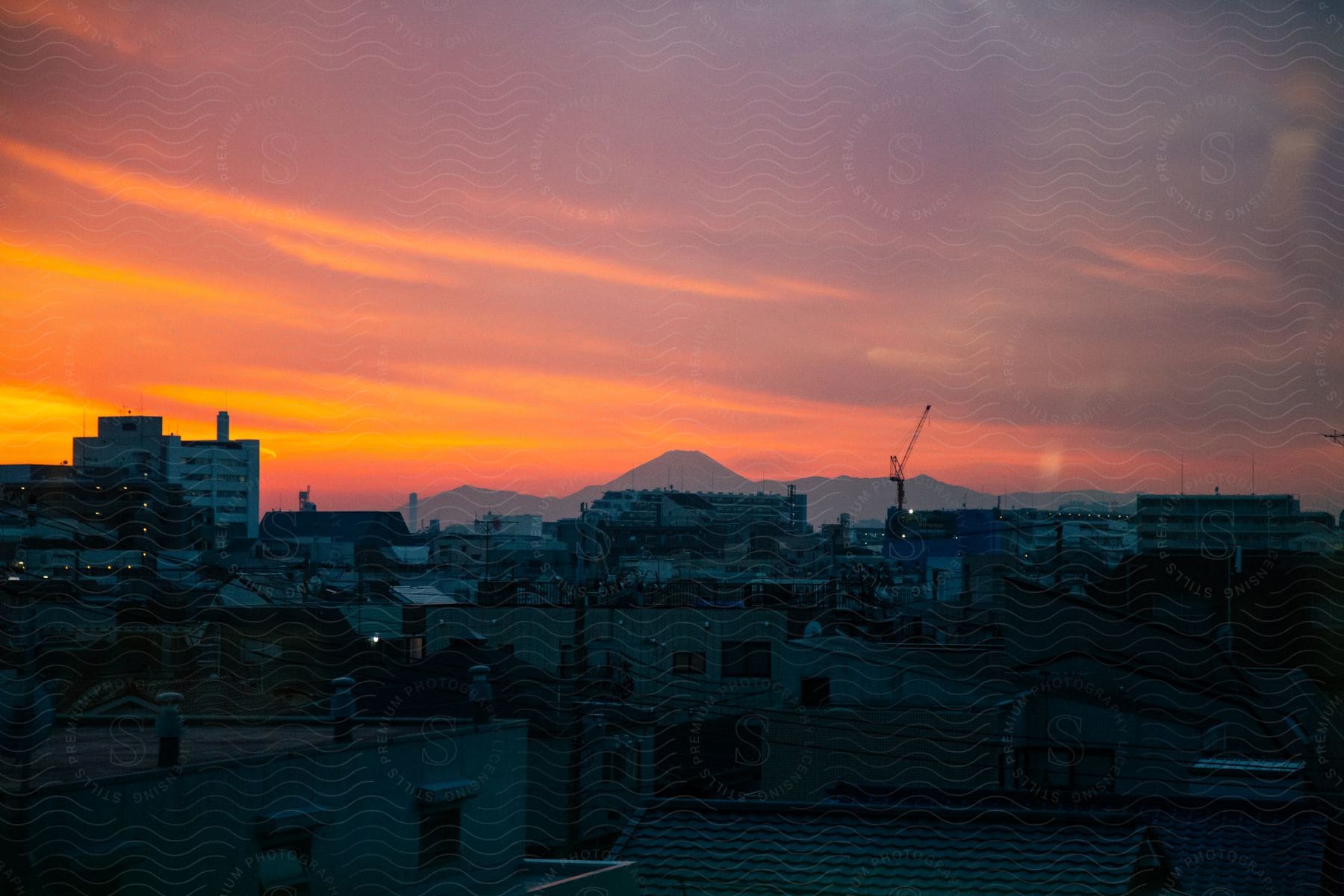 A Cityscape With Buildings And A Red Sky At Morning