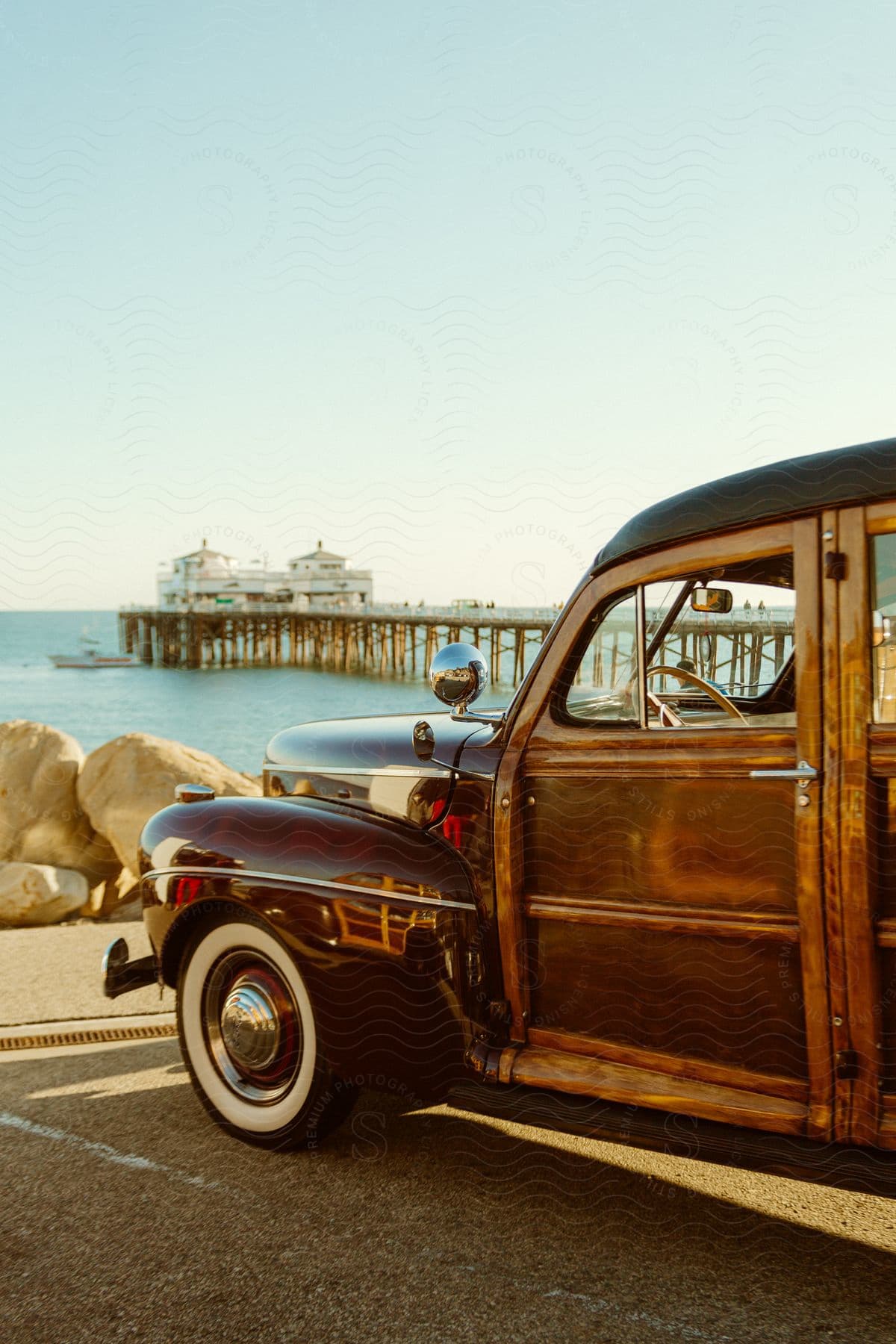 Classic car parked on a pier by the water