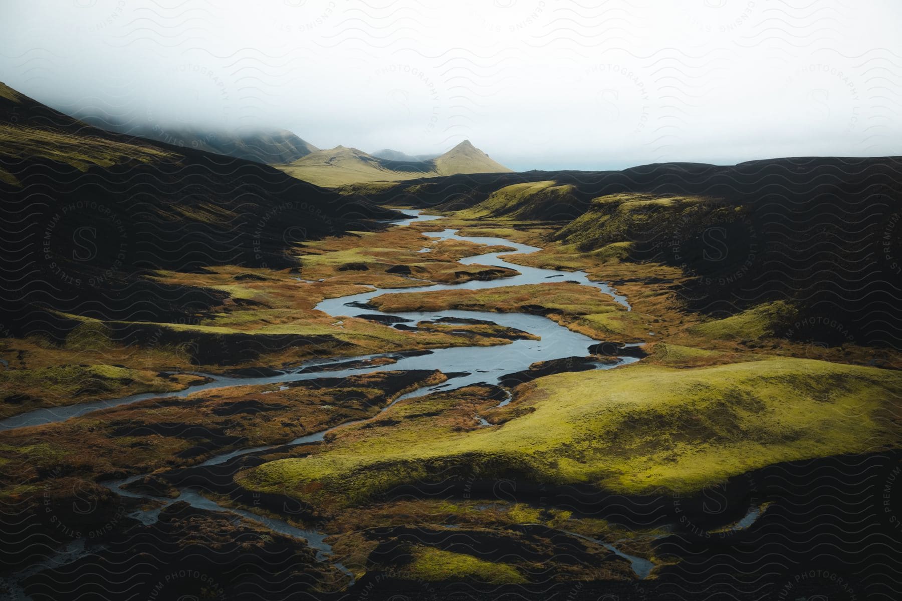 Green mossy landscape with streams and hills near álftavatnin iceland