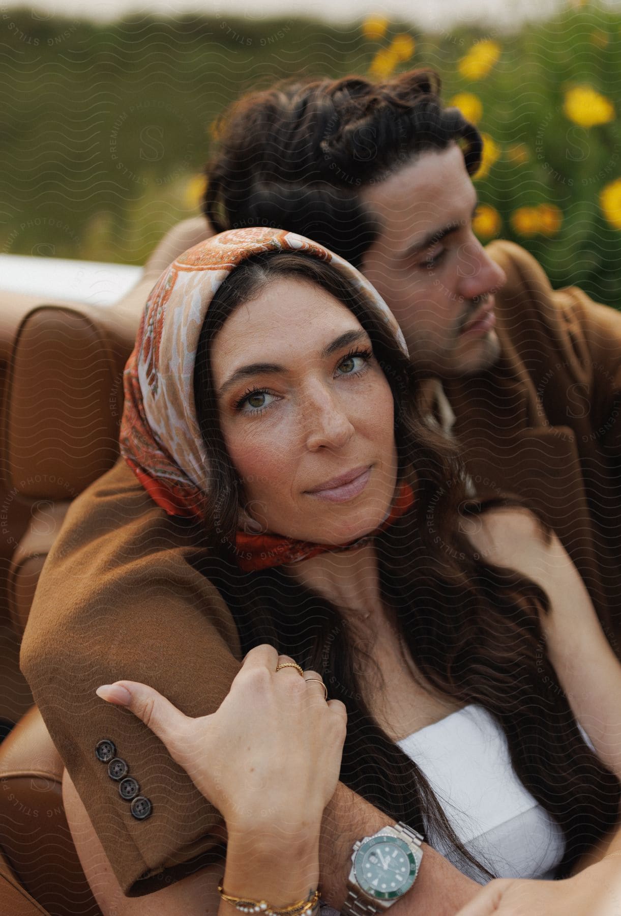 A man and woman cuddling in a car