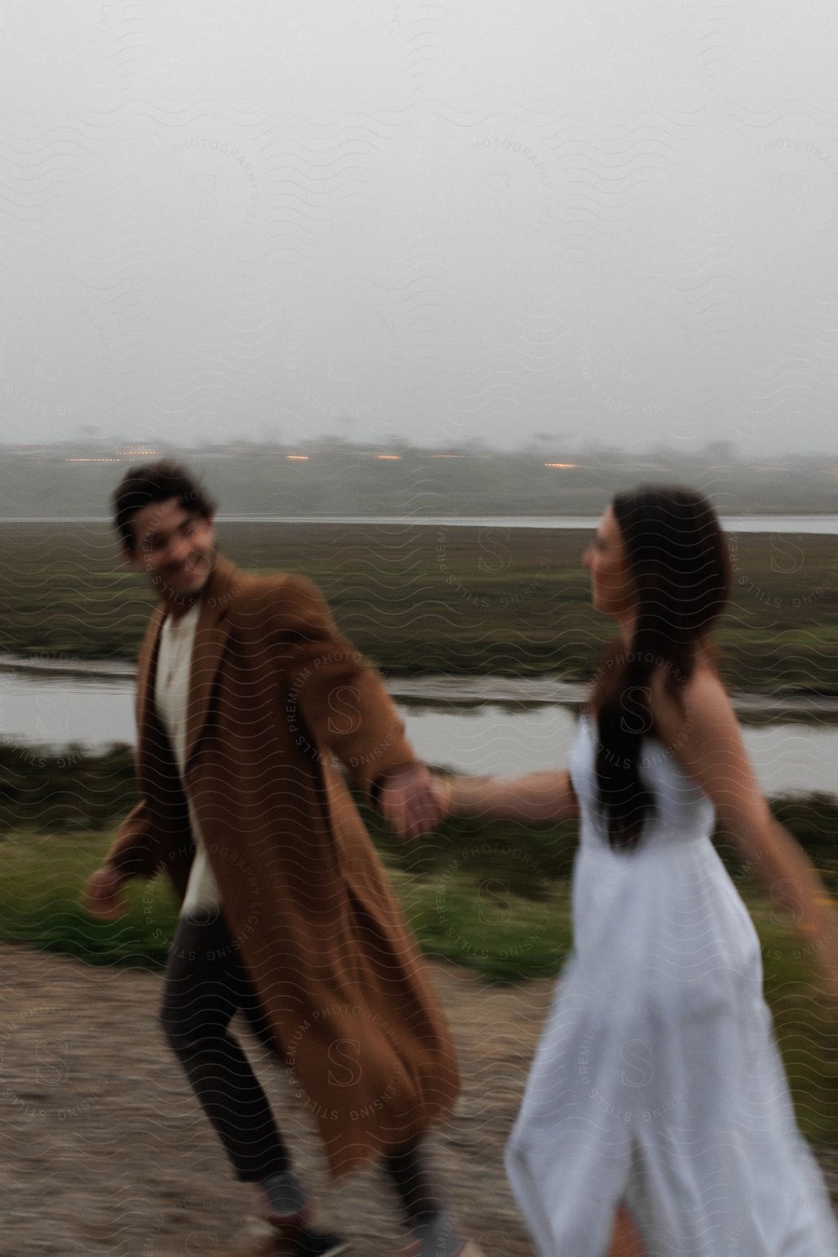 Stock photo of two lovers walk hand in hand on a street their smiles reflecting joy