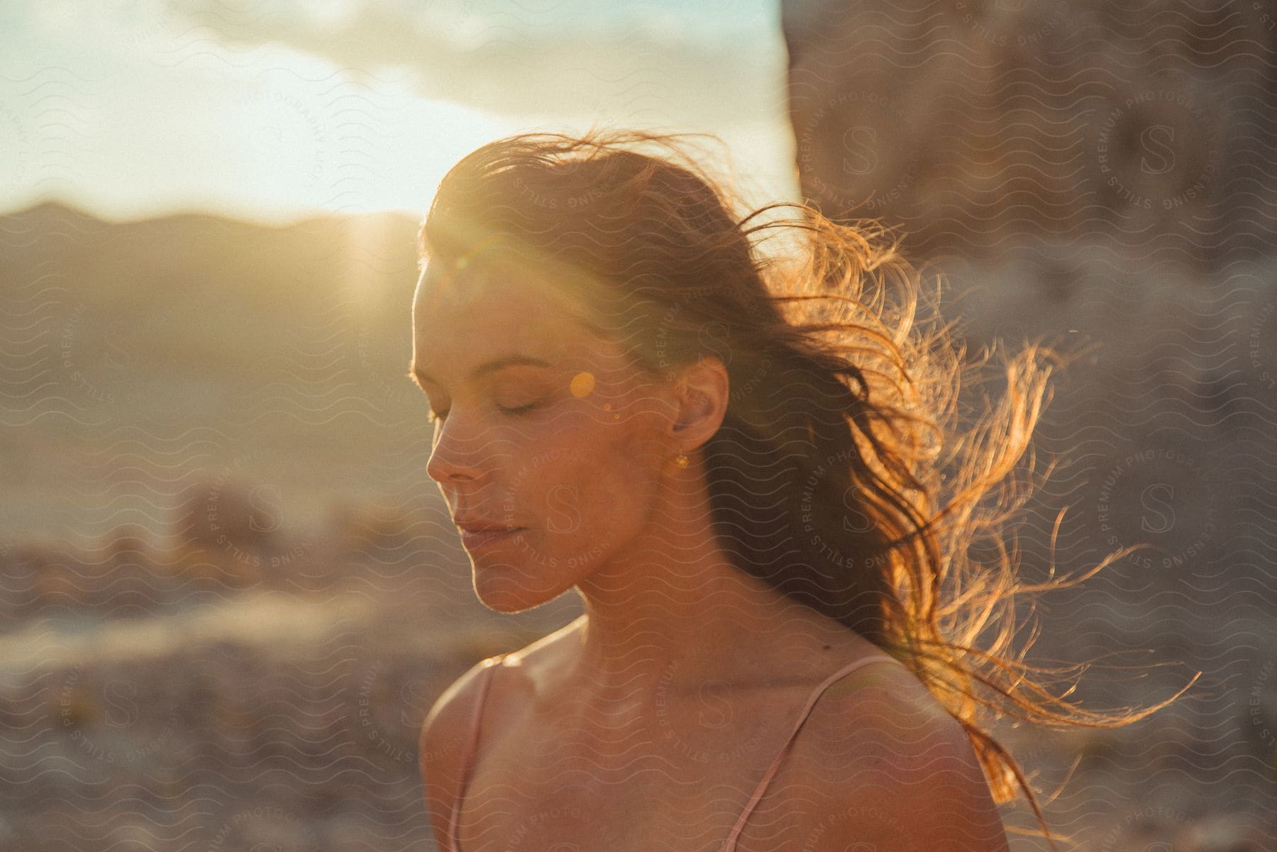 Girl posing with reflections of sunlight in the outdoors at dusk or dawn