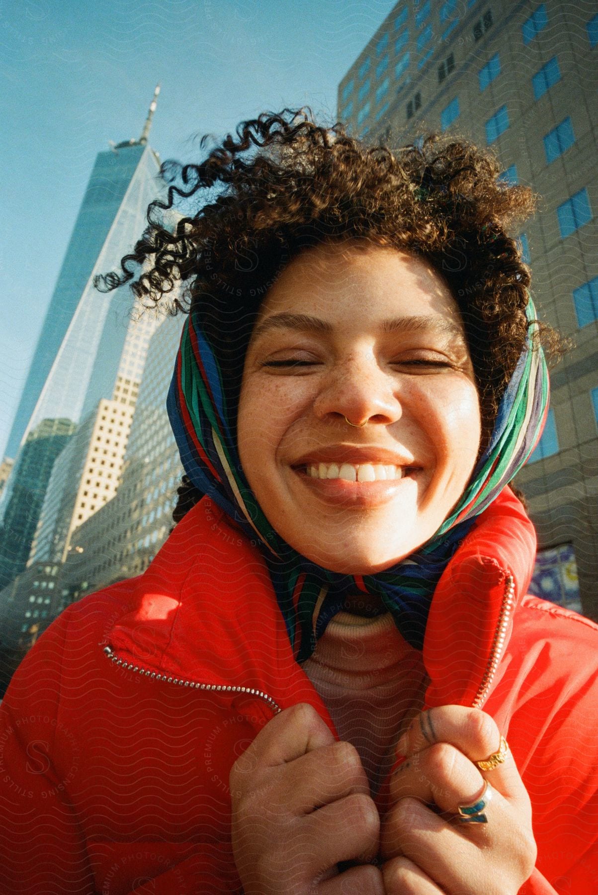 A smiling woman walking through a city street in downtown manhattan