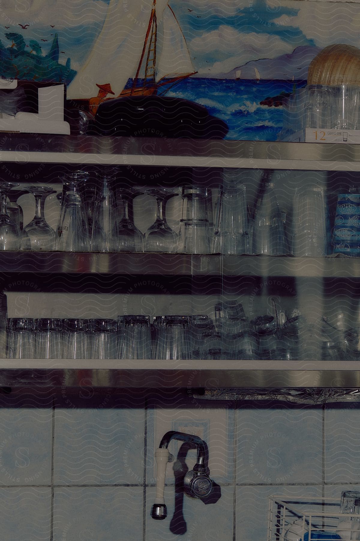 drinking glasses line the shelves in a restaurant kitchen