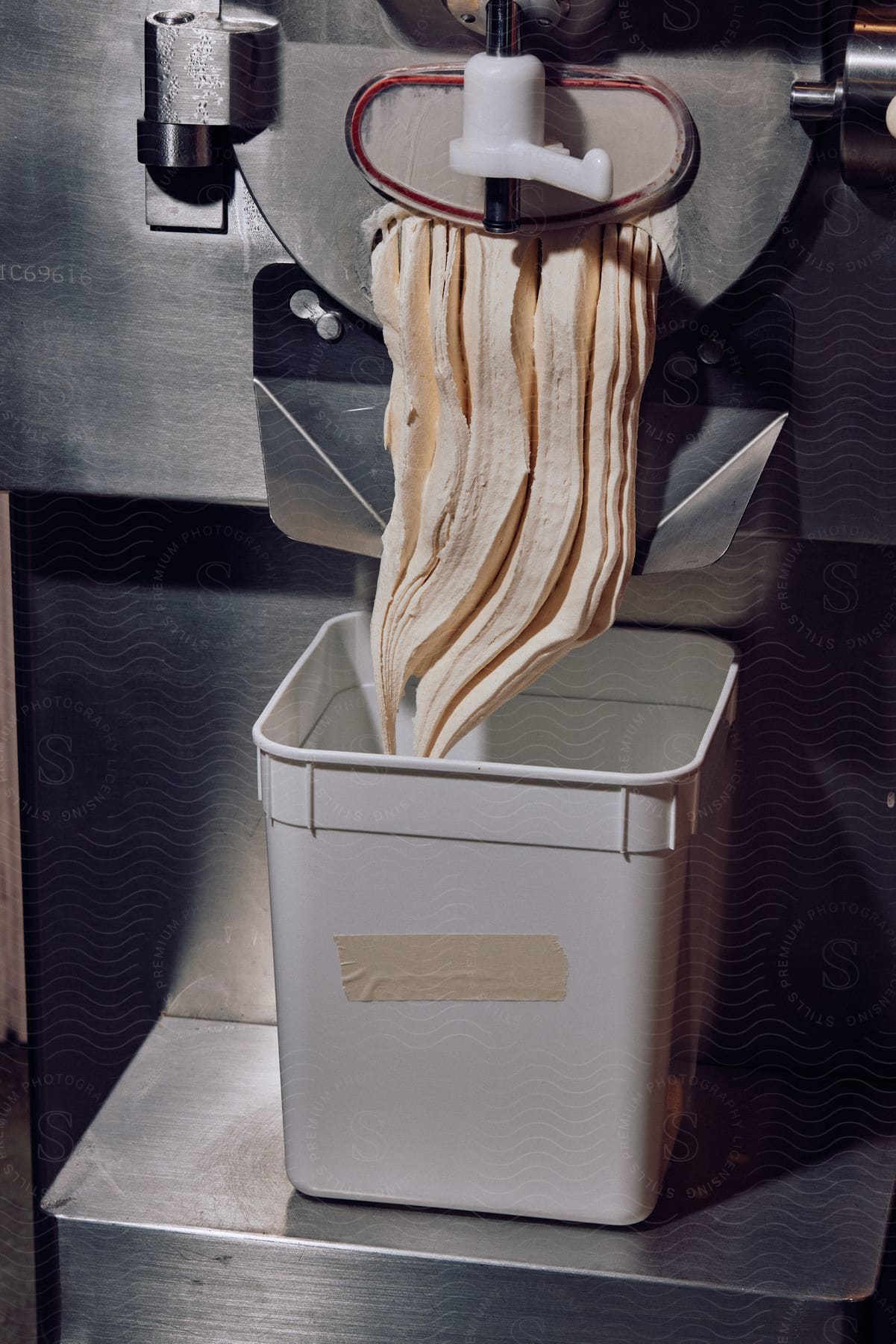 Stock photo of machine processing icecream in an industrial cooking setting