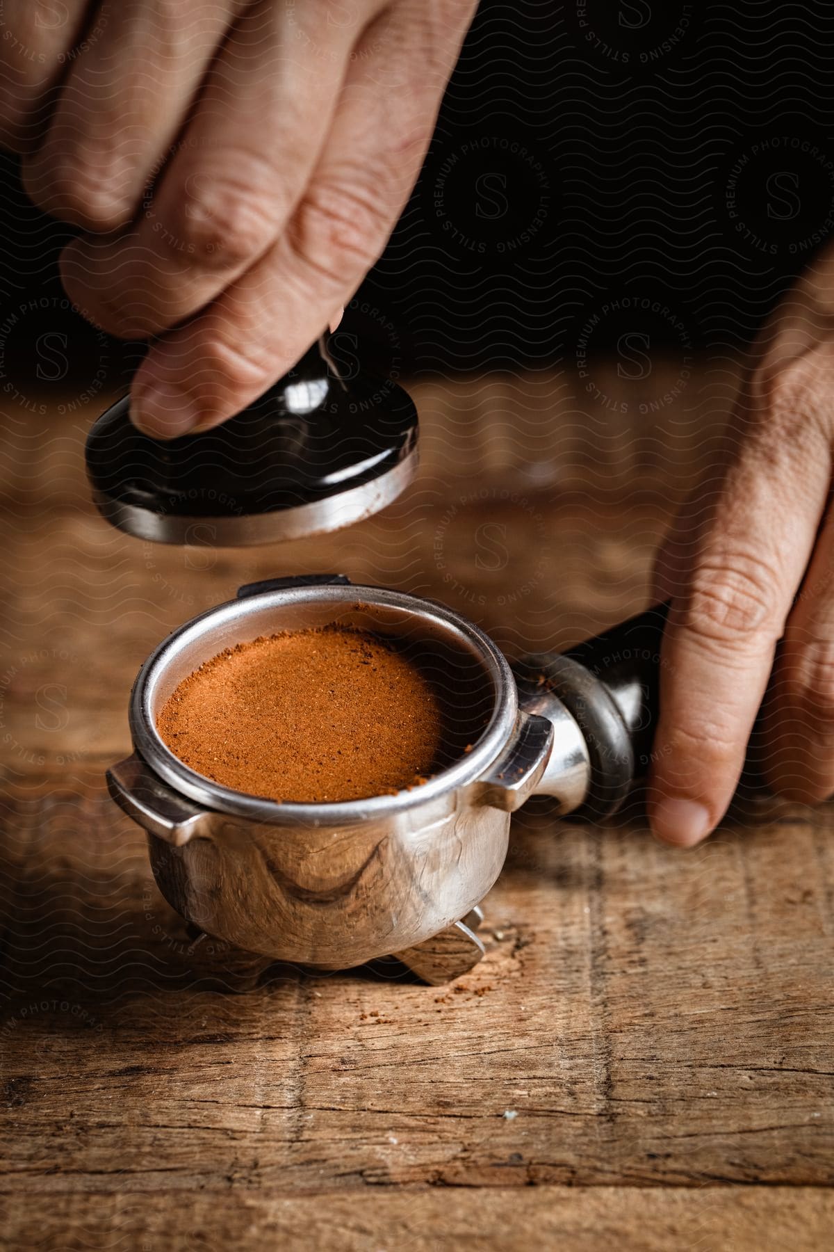 Close up of hand pressing coffee tamper