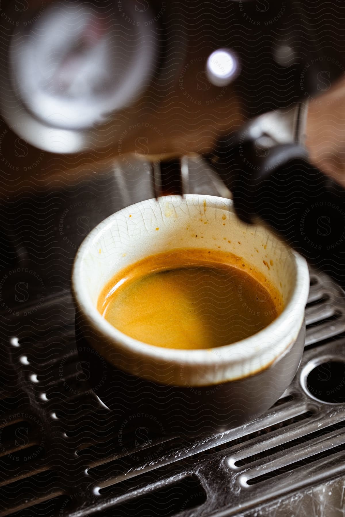 Espresso coffee being prepared by a machine in an interior location