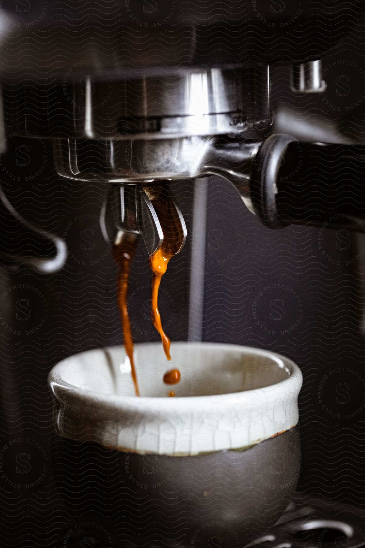 Espresso machine preparing coffee in an interior setting with low key lighting