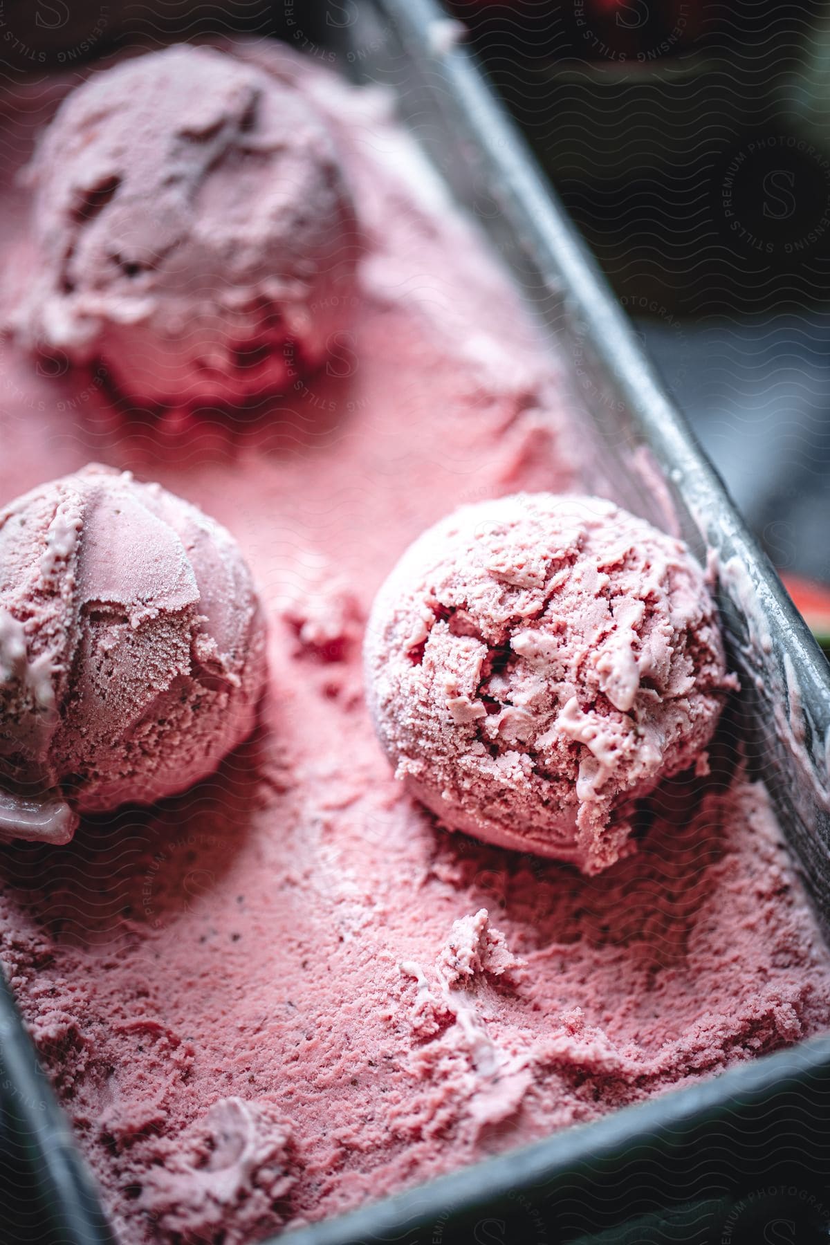 Redcolored ice cream in a metal container