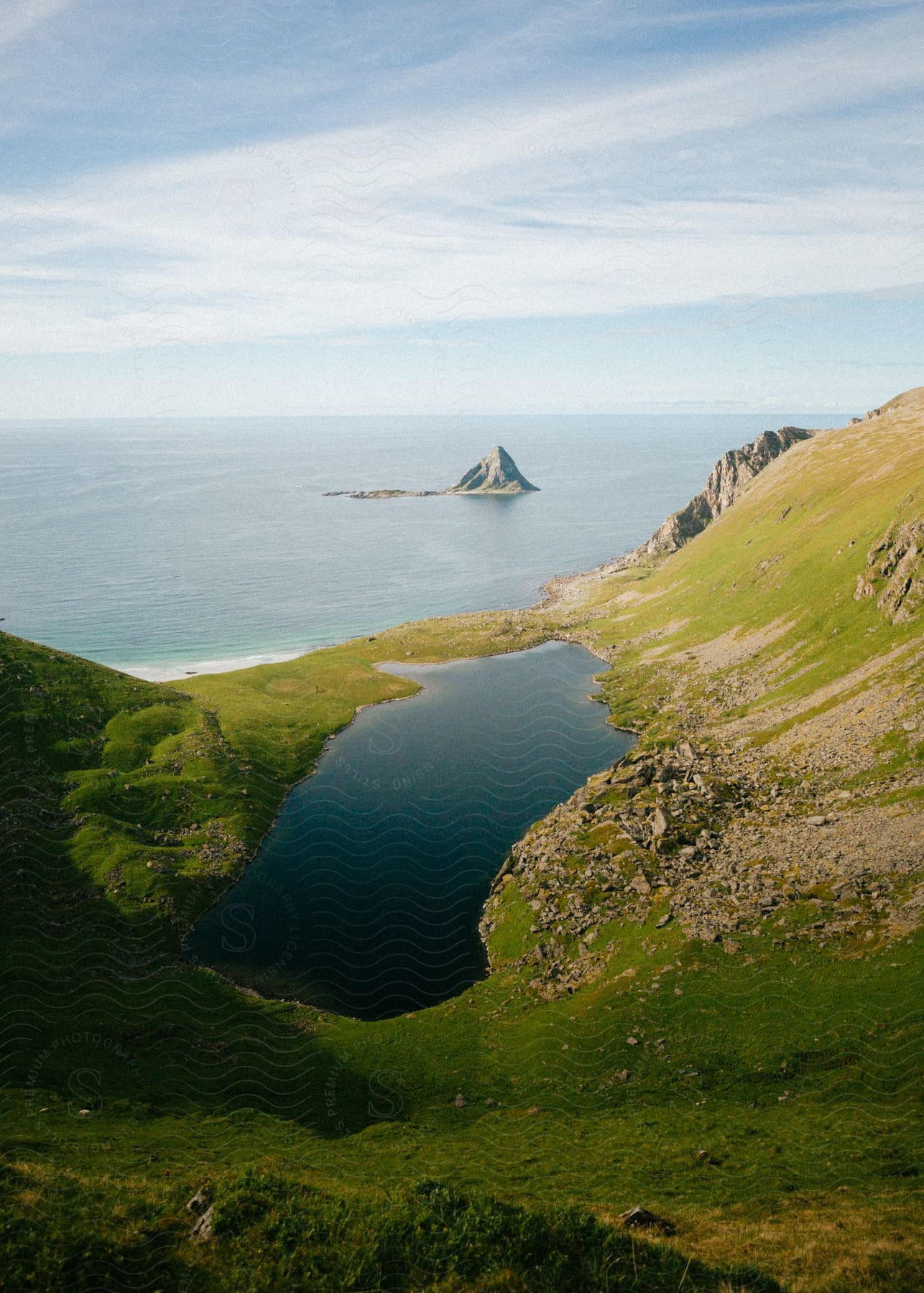 A scenic view of a mountain landscape with a lake and shoreline