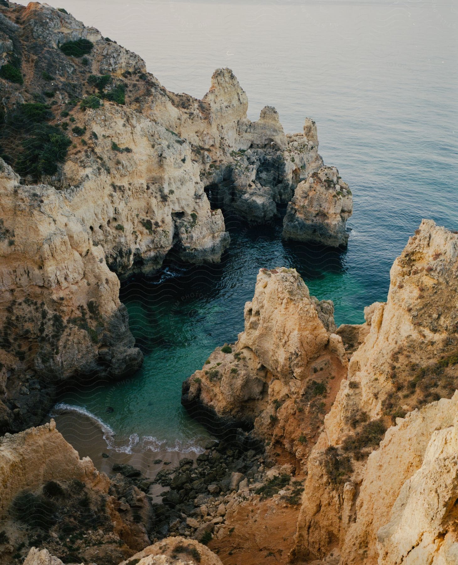 A secluded beach in a coastal cove next to the ocean