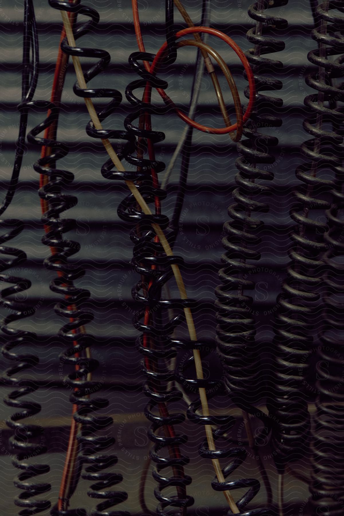 Stock photo of curly wires create a complex web in an interior room