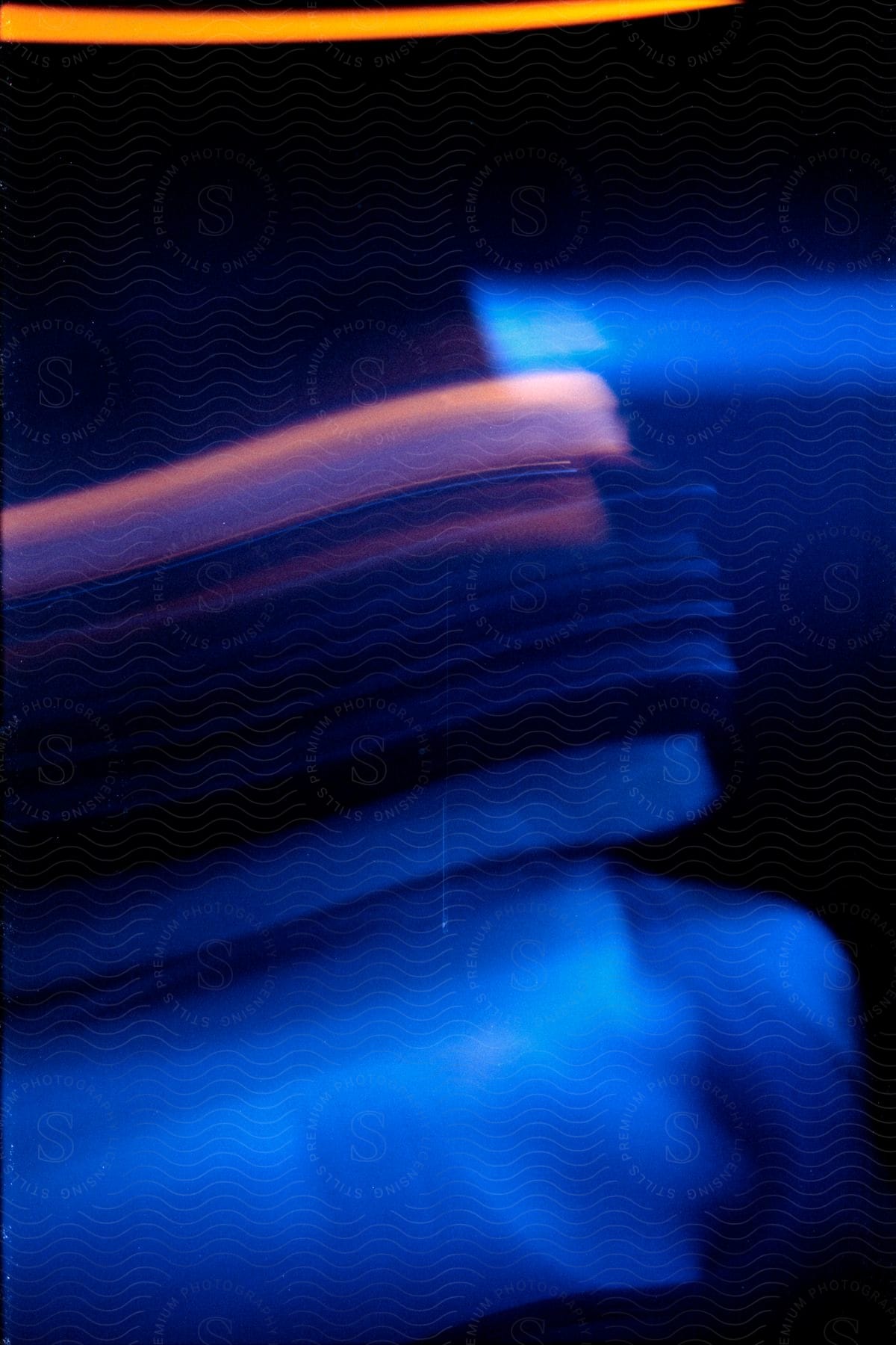 Abstract image with a person and blurry lights distorted by motion blur