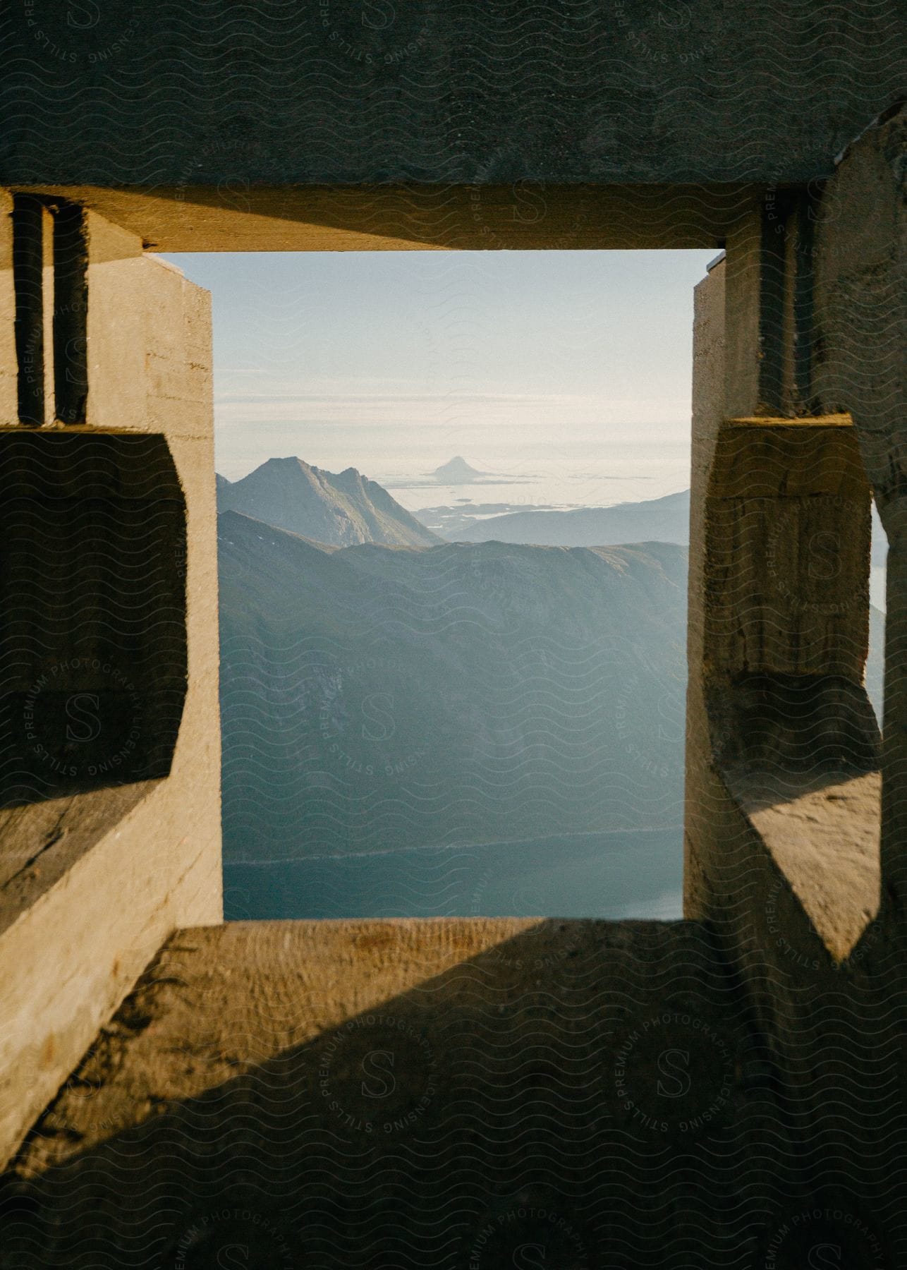 An open structure with shadows and mountains in the background