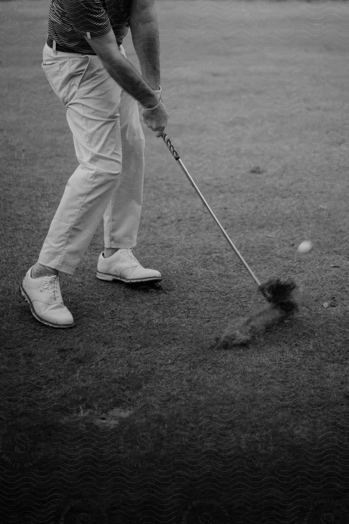 Man playing golf on a grassy field