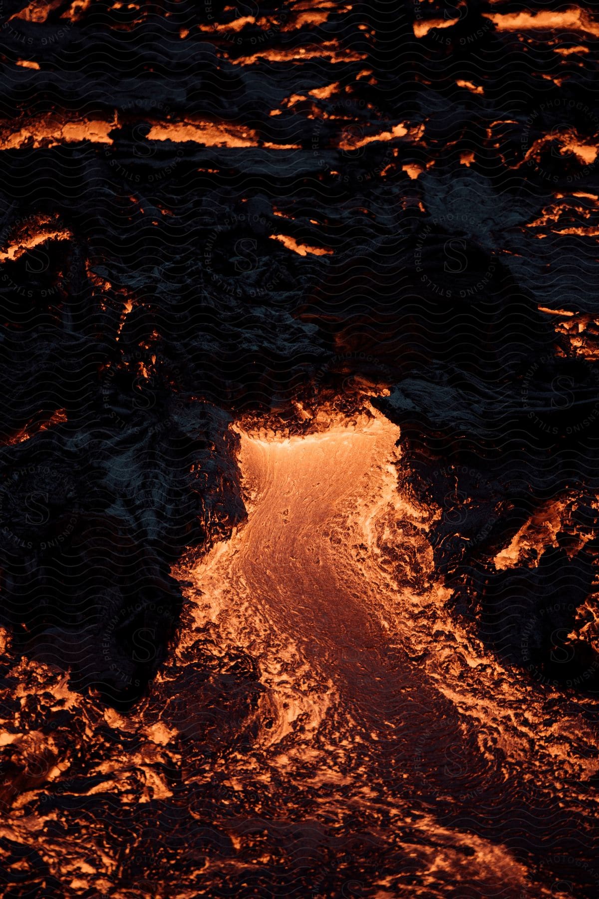 Red stream of liquid flowing through a dark background