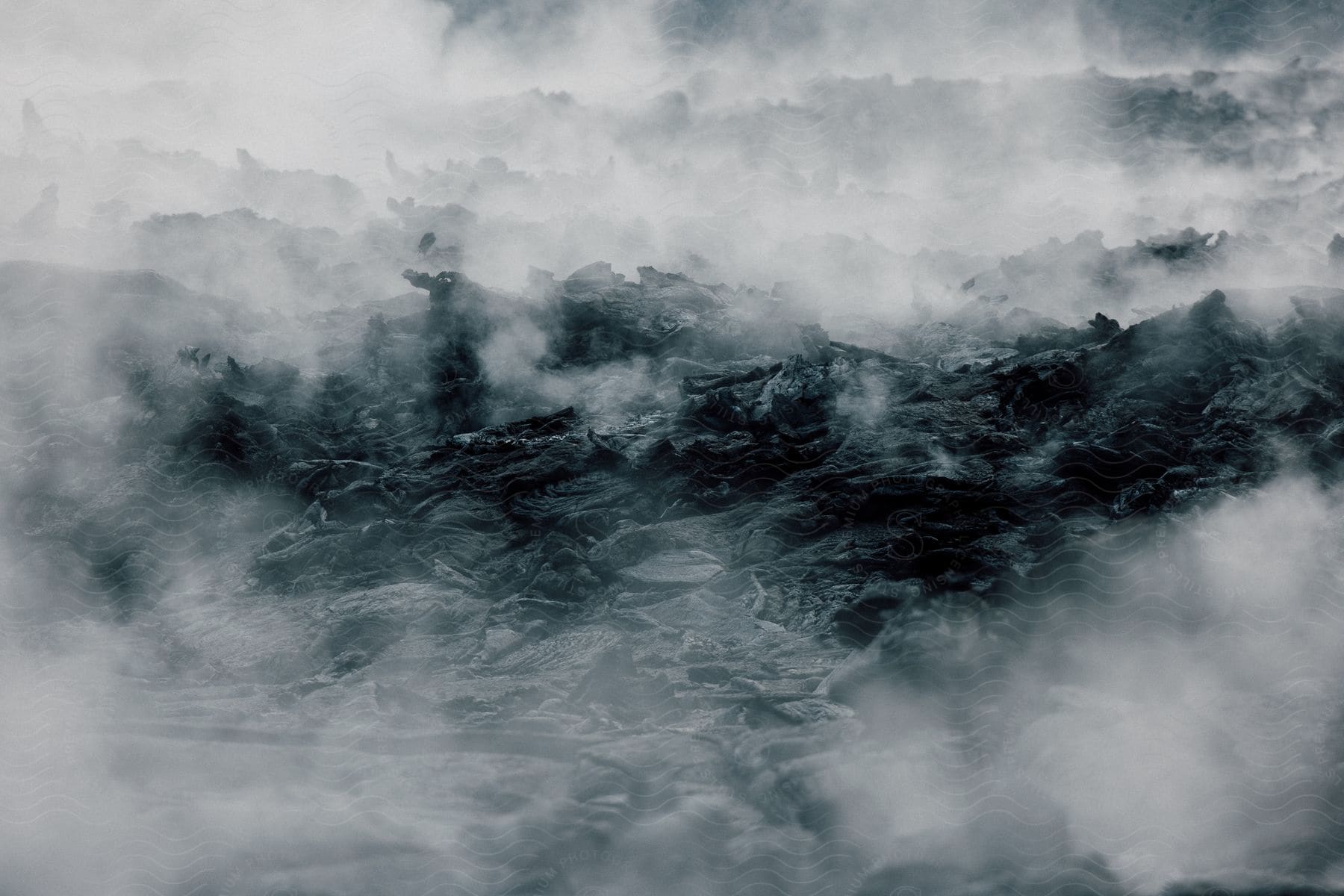 A misty landscape with rocky terrain resembling smoke