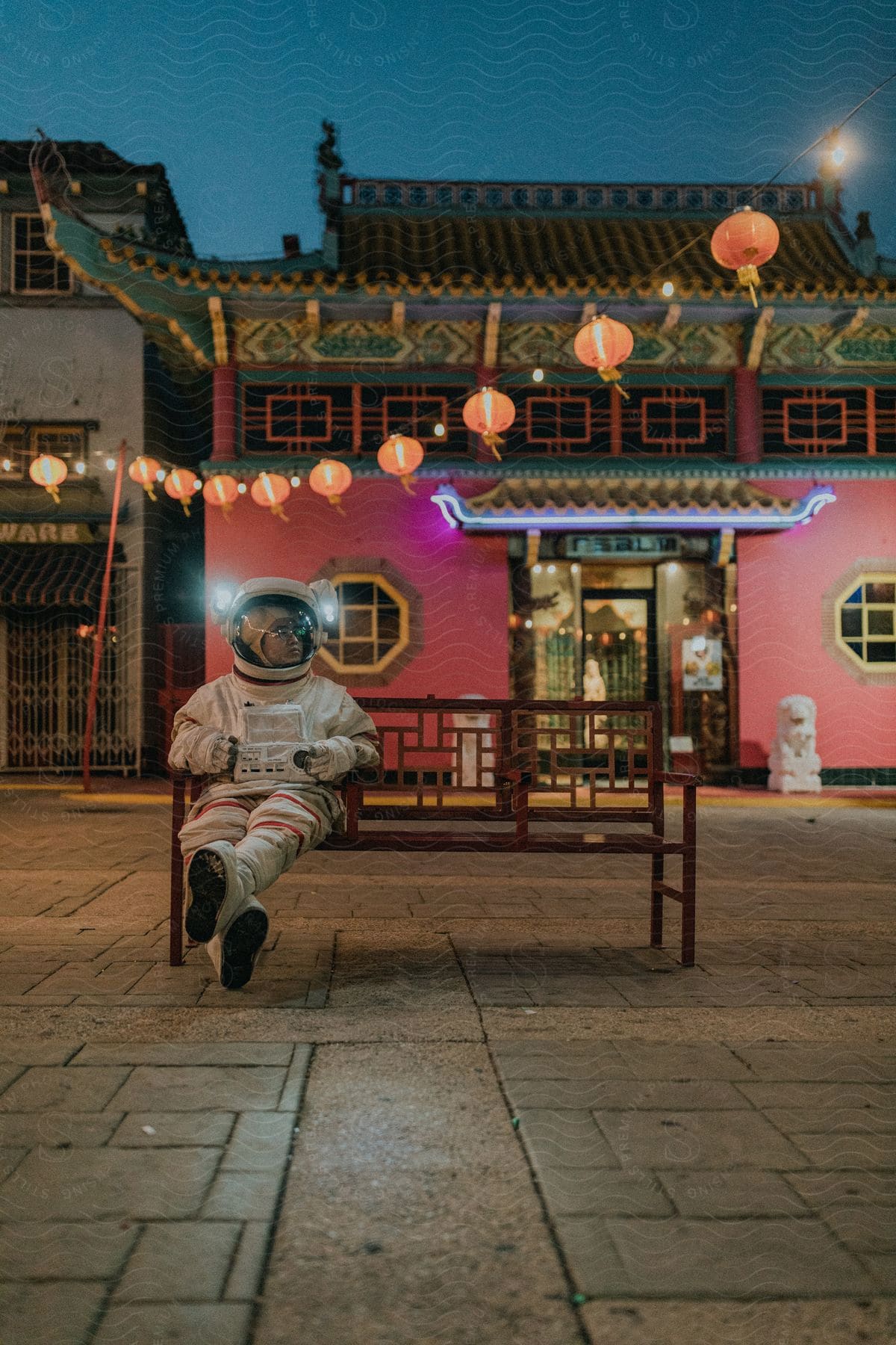 Astronaut sitting on a city bench with chinese decorations