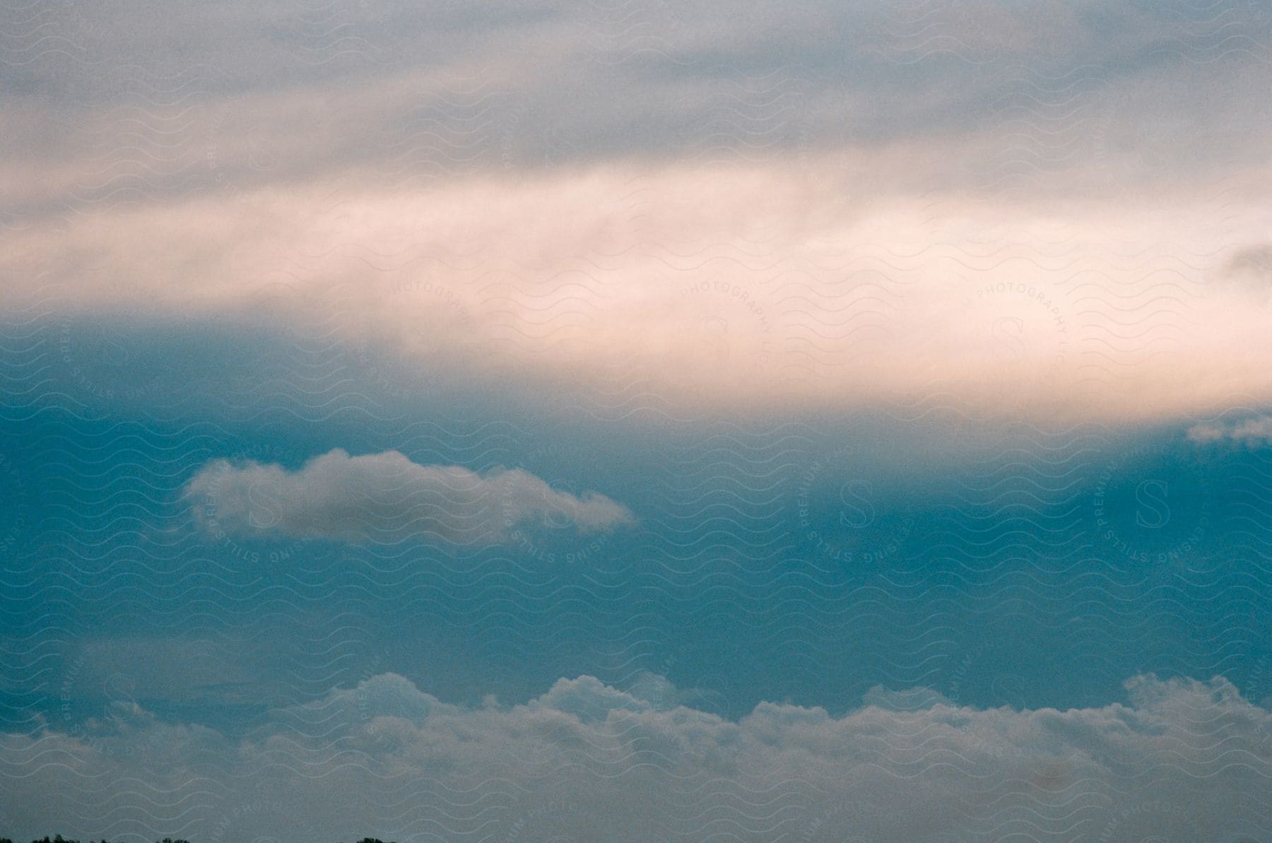 An empty sky with blue cumulus clouds