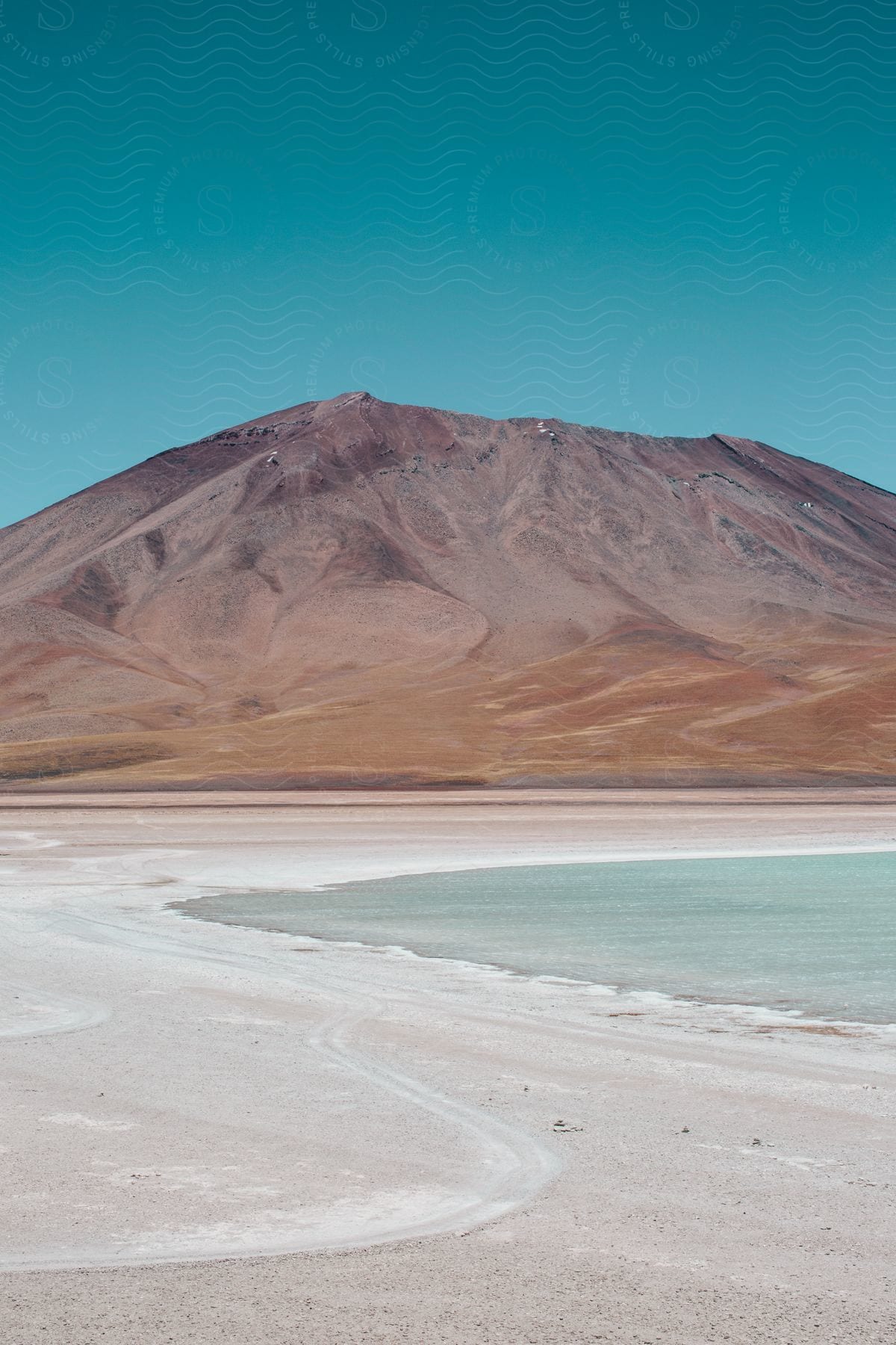 Wide landscape shot of a mountain in the atacama desert next to a water source